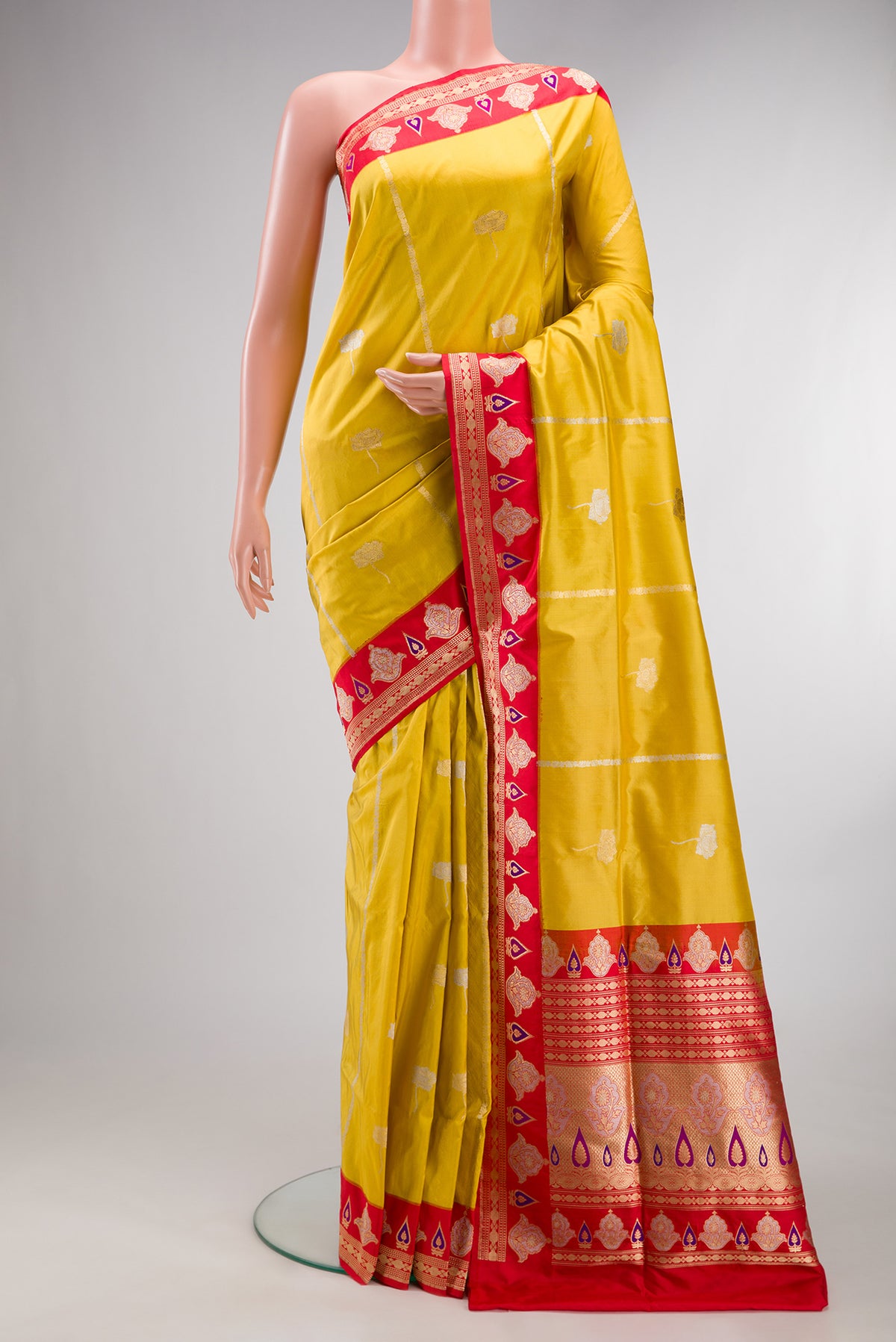 Pure Silk Yellow Banarasi Saree with Zari Butta on the body and Fancy Border.  displayed on a mannequin
