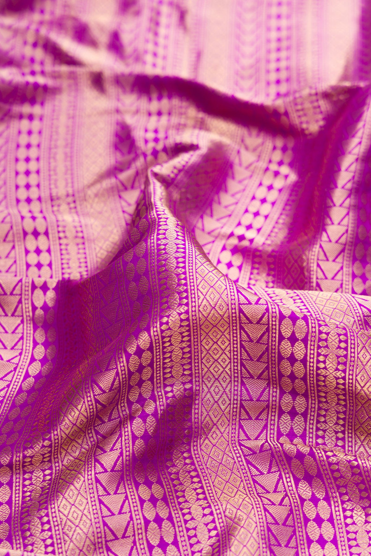 Close up of Pure Silk Purple Banarasi Saree with Zari Brocade on the body and Fancy Border.  displaying folds