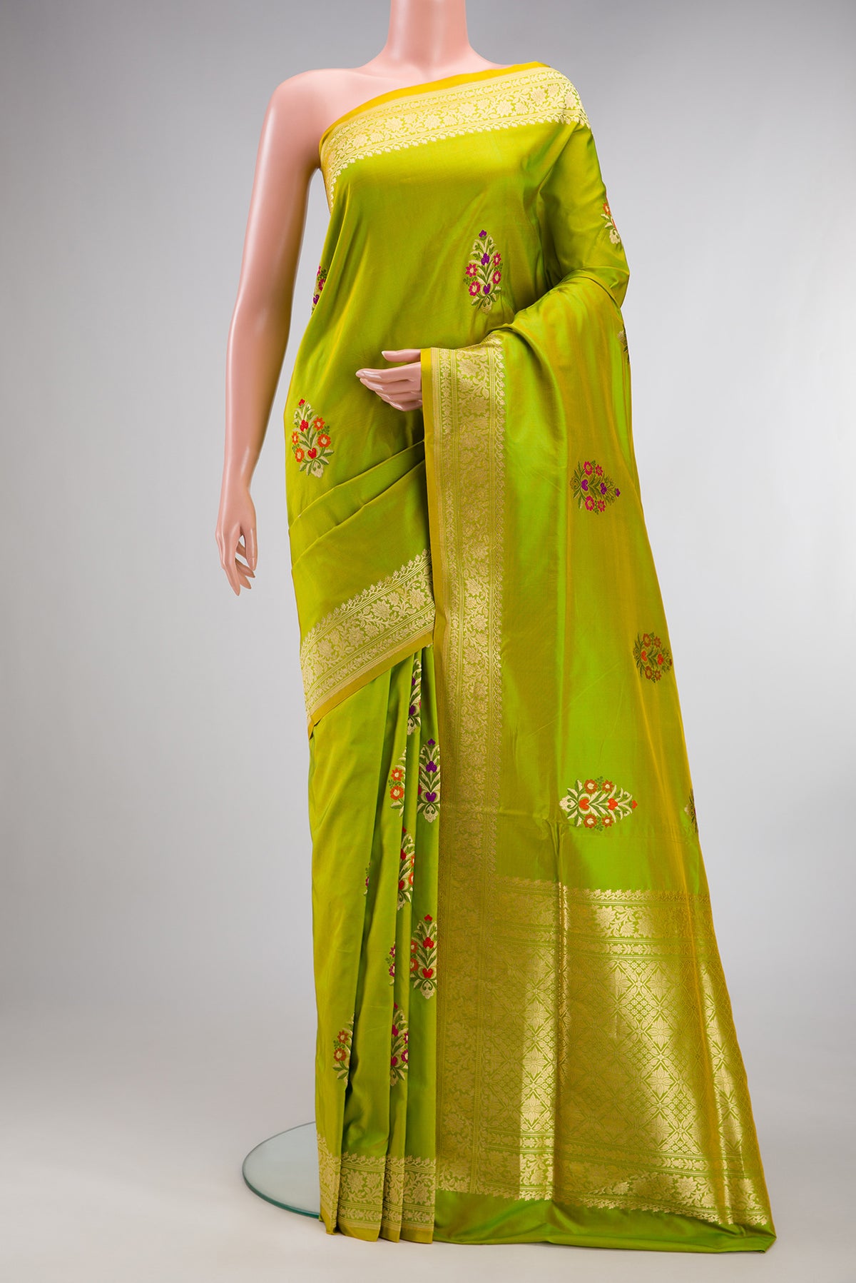 Pure Silk Parrot Green Dual Tone Banarasi Saree with Zari And Thread Butta on the body and Zari Border.  displayed on a mannequin