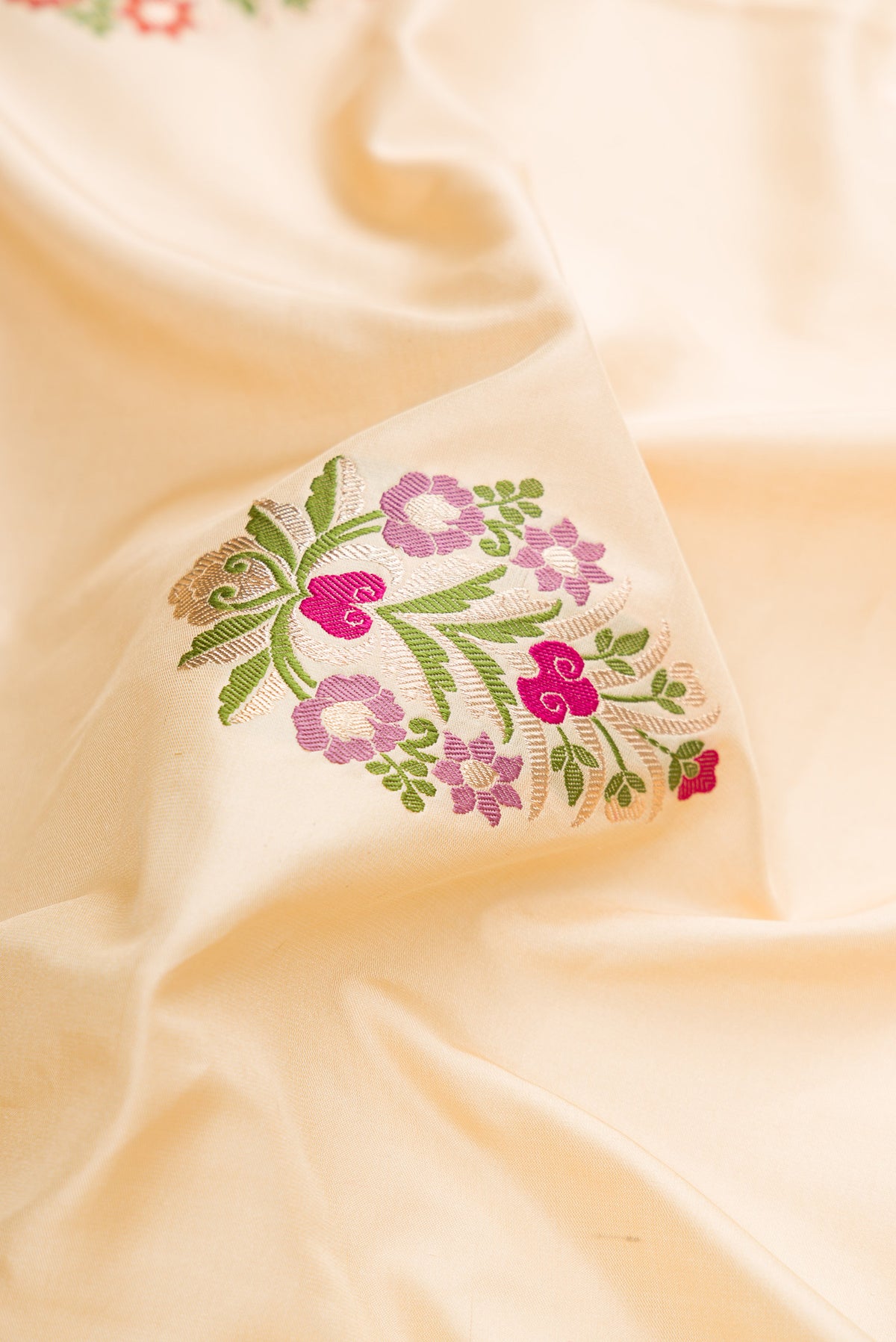 Close up of Pure Silk Sandal Banarasi Saree with Zari And Thread Butta on the body and Zari Border.  displaying folds