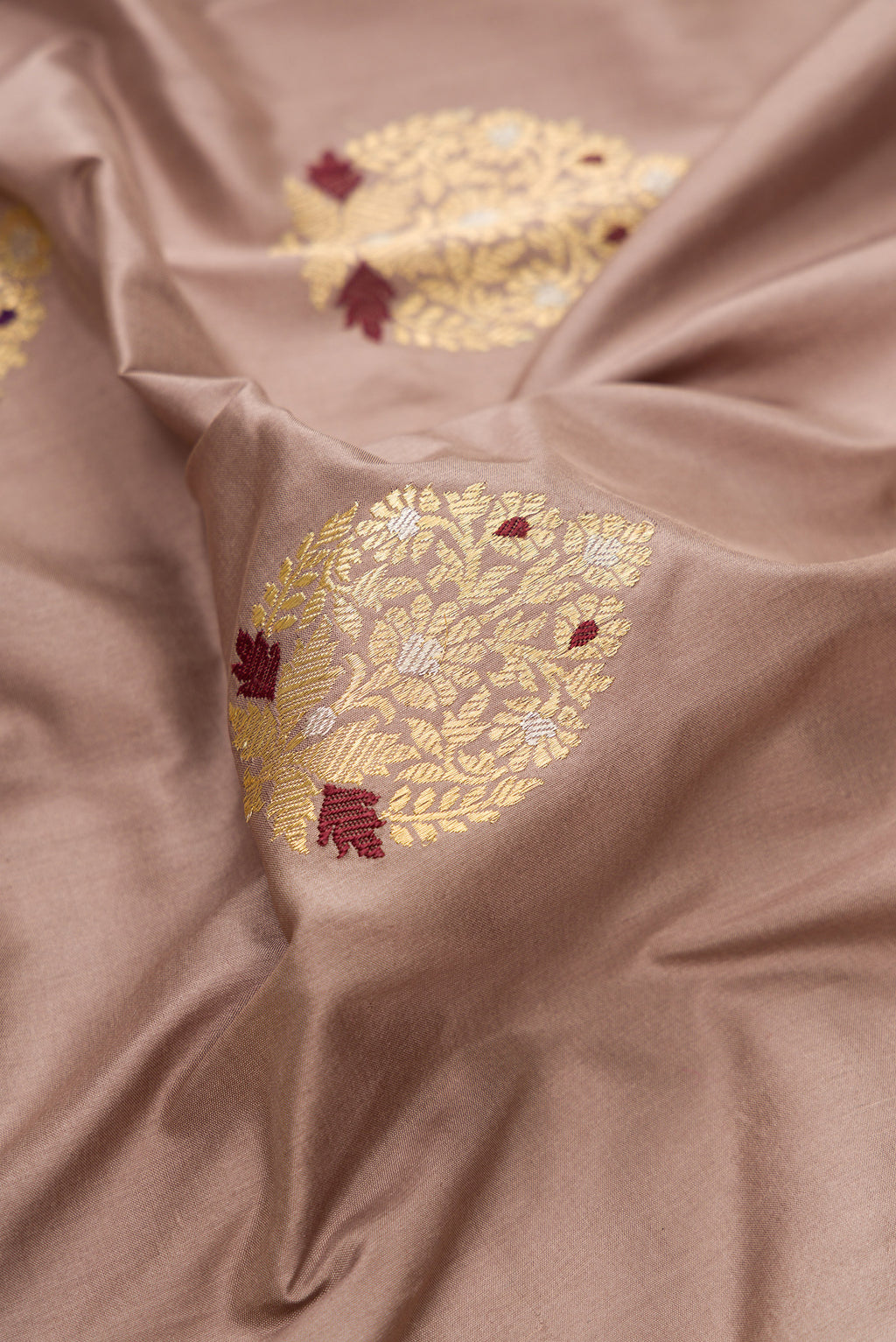 Close up of Pure Silk Brown Banarasi Saree with Zari And Thread Butta on the body and Zari Border.  displaying folds