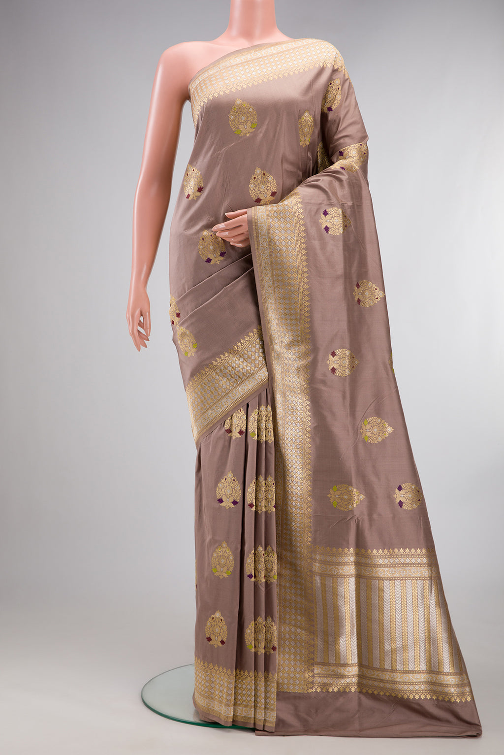 Pure Silk Brown Banarasi Saree with Zari And Thread Butta on the body and Zari Border.  displayed on a mannequin