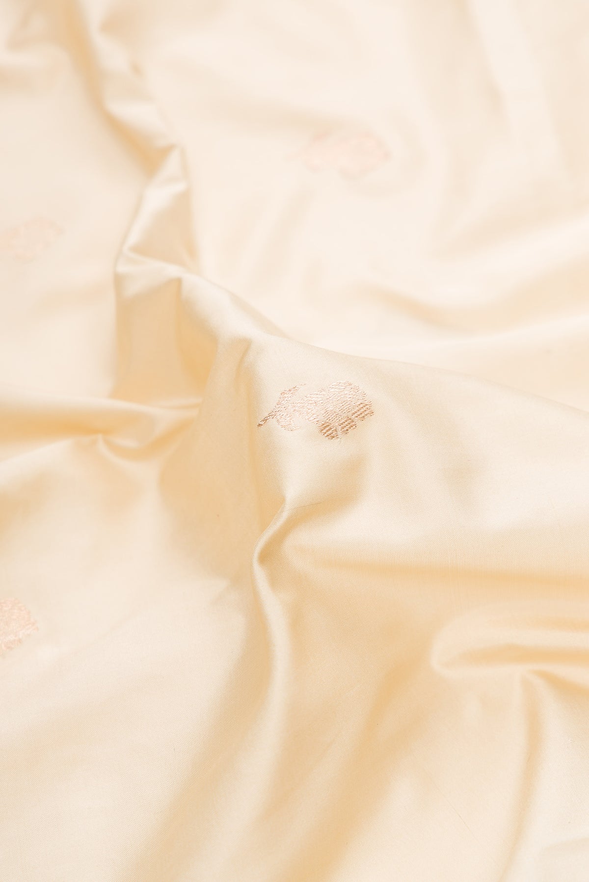 Close up of Pure Silk Sandal Banarasi Saree with Zari Butta on the body and Fancy Border.  displaying folds