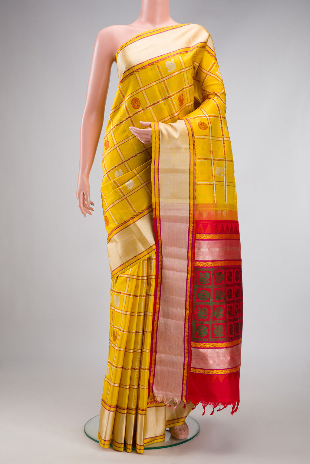 Yellow Kanchipuram Silk Saree with Checked design on the body and Thread Border.  displayed on a mannequin