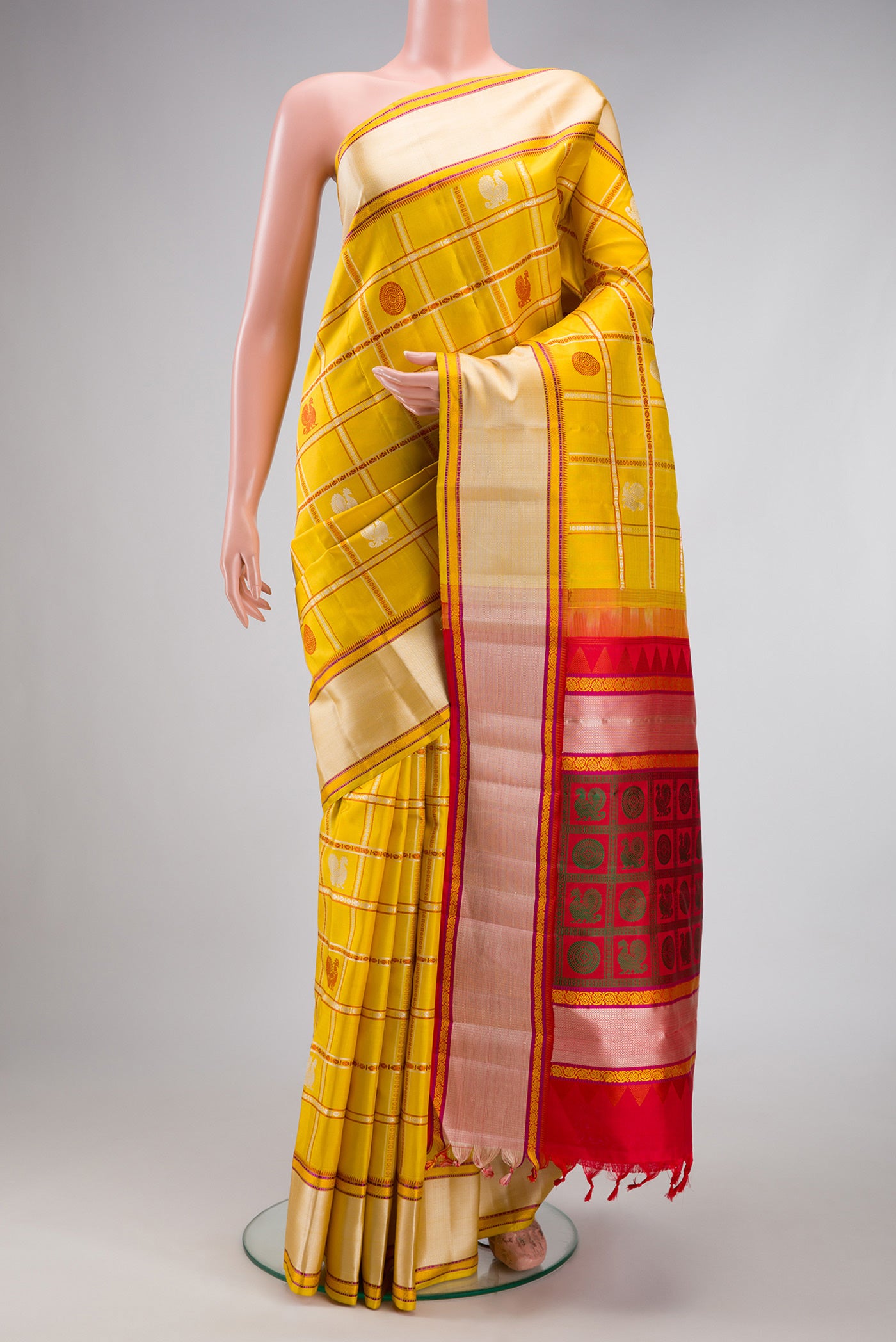 Yellow Kanchipuram Silk Saree with Checked design on the body and Thread Border.  displayed on a mannequin