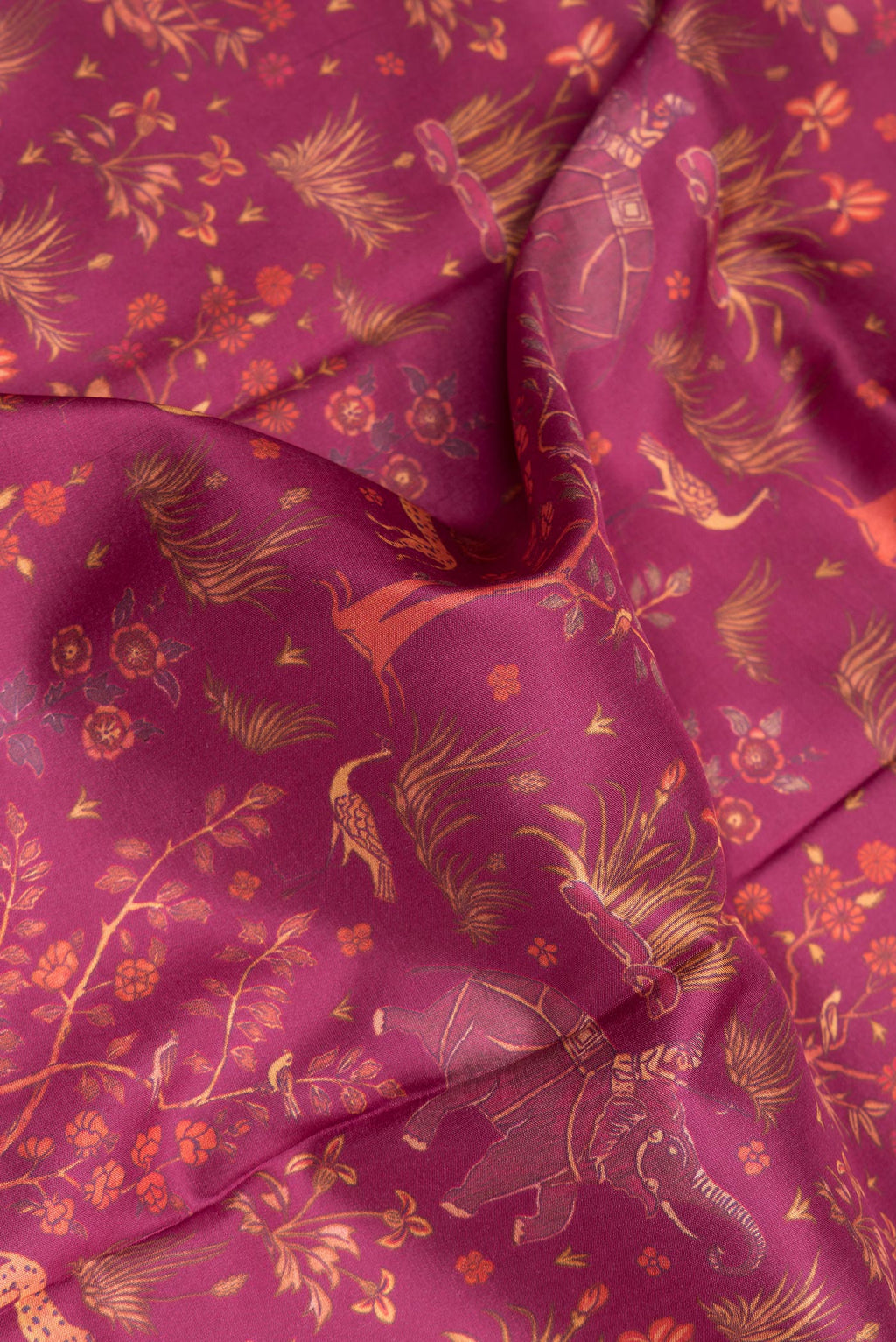 Close up of Pure Silk Magenta Dual Tone Kanchipuram Saree with Printed design on the body and Embroidery Border.  displaying folds