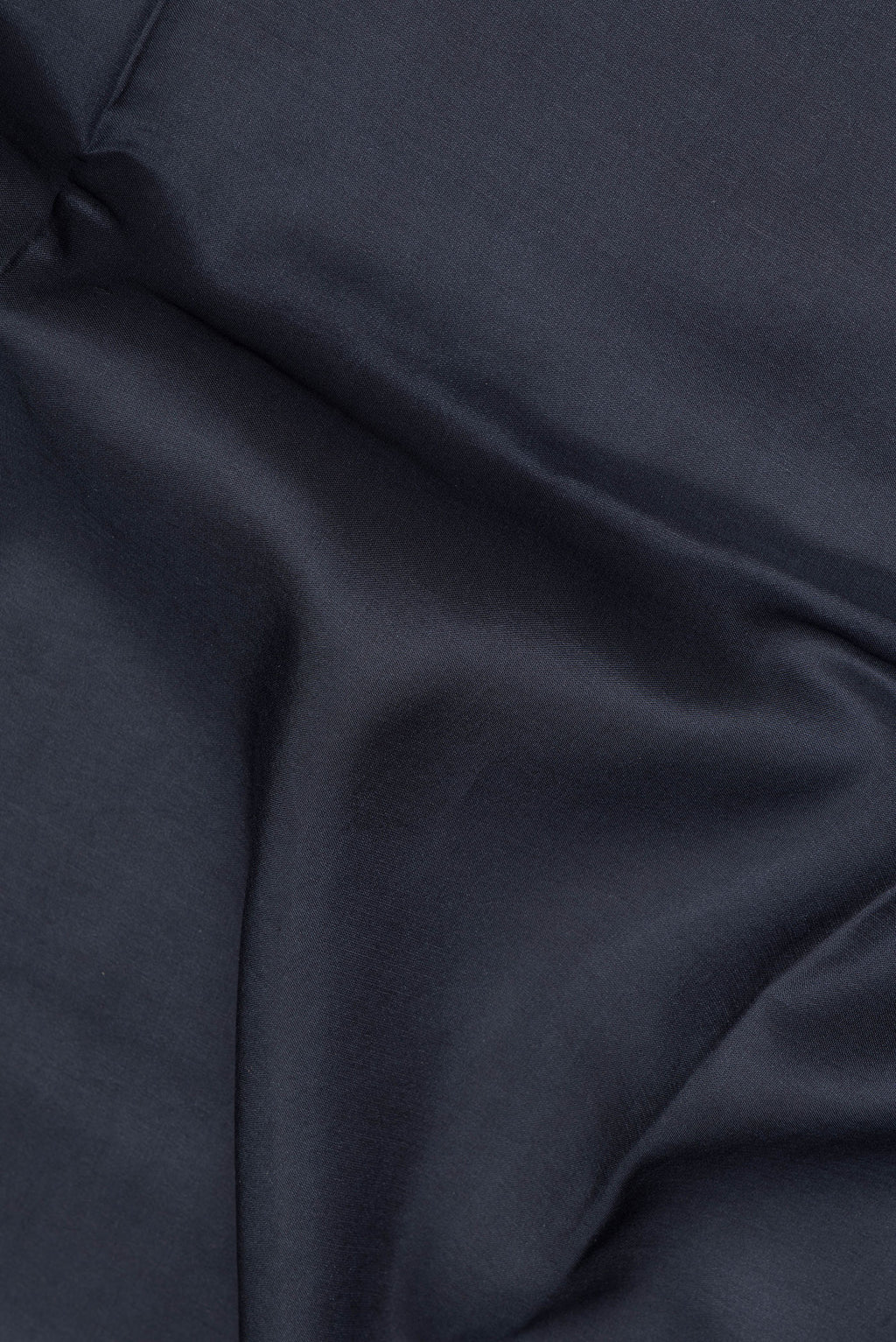 Close up of Black Mysore Crepe Saree with Plain Body and Printed Border.  displaying folds