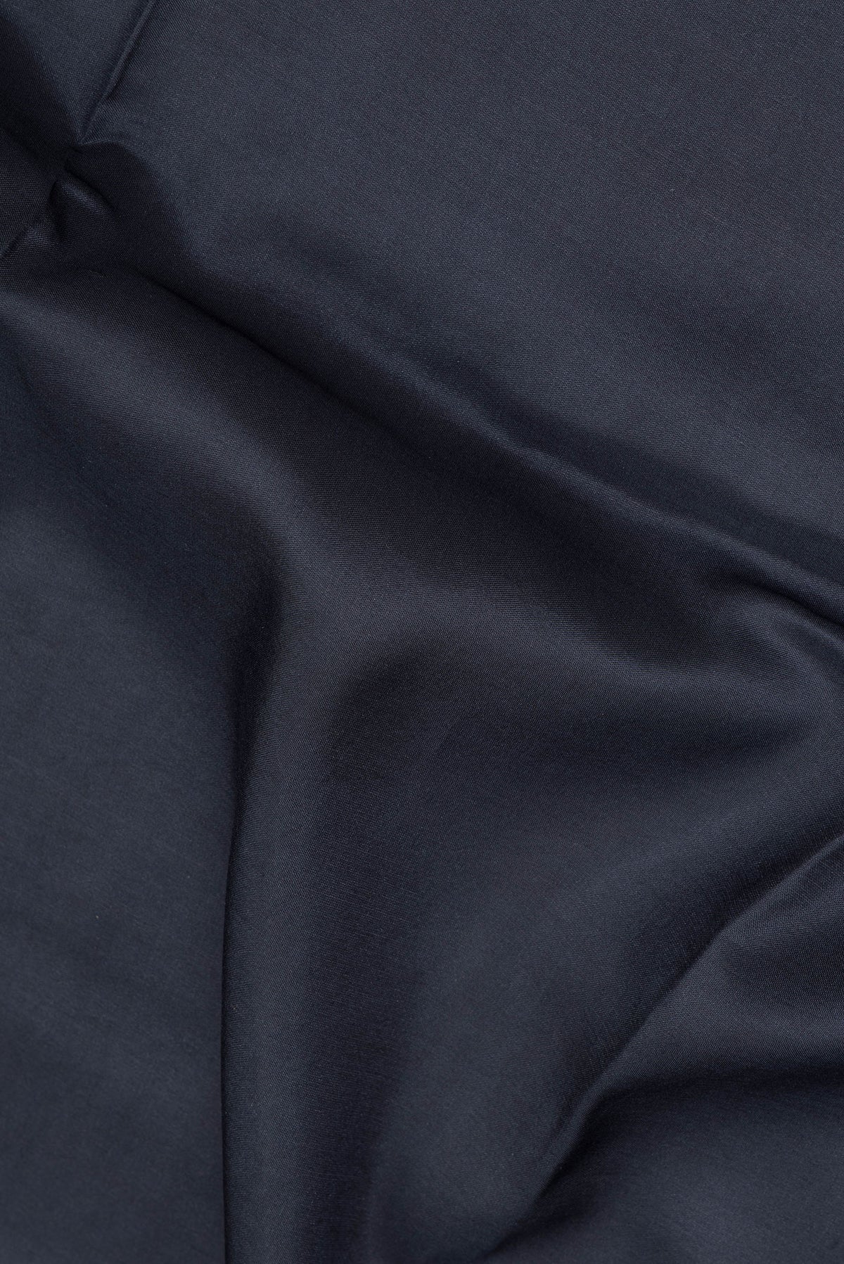 Close up of Black Mysore Crepe Saree with Plain Body and Printed Border.  displaying folds