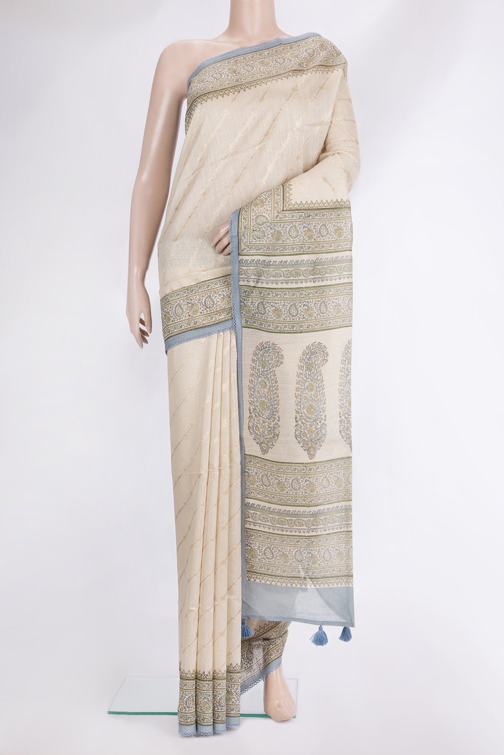 Cream Tussar Saree with Zari Butta on the body and Printed Border.  displayed on a mannequin
