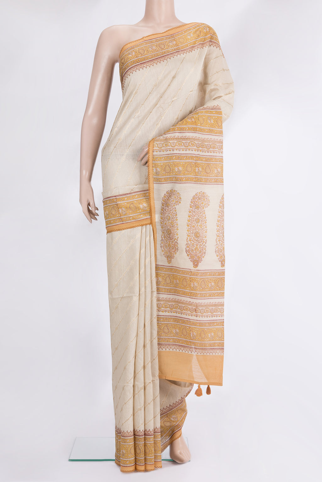 Beige Tussar Saree with Zari Butta on the body and Embroidered Border.  displayed on a mannequin