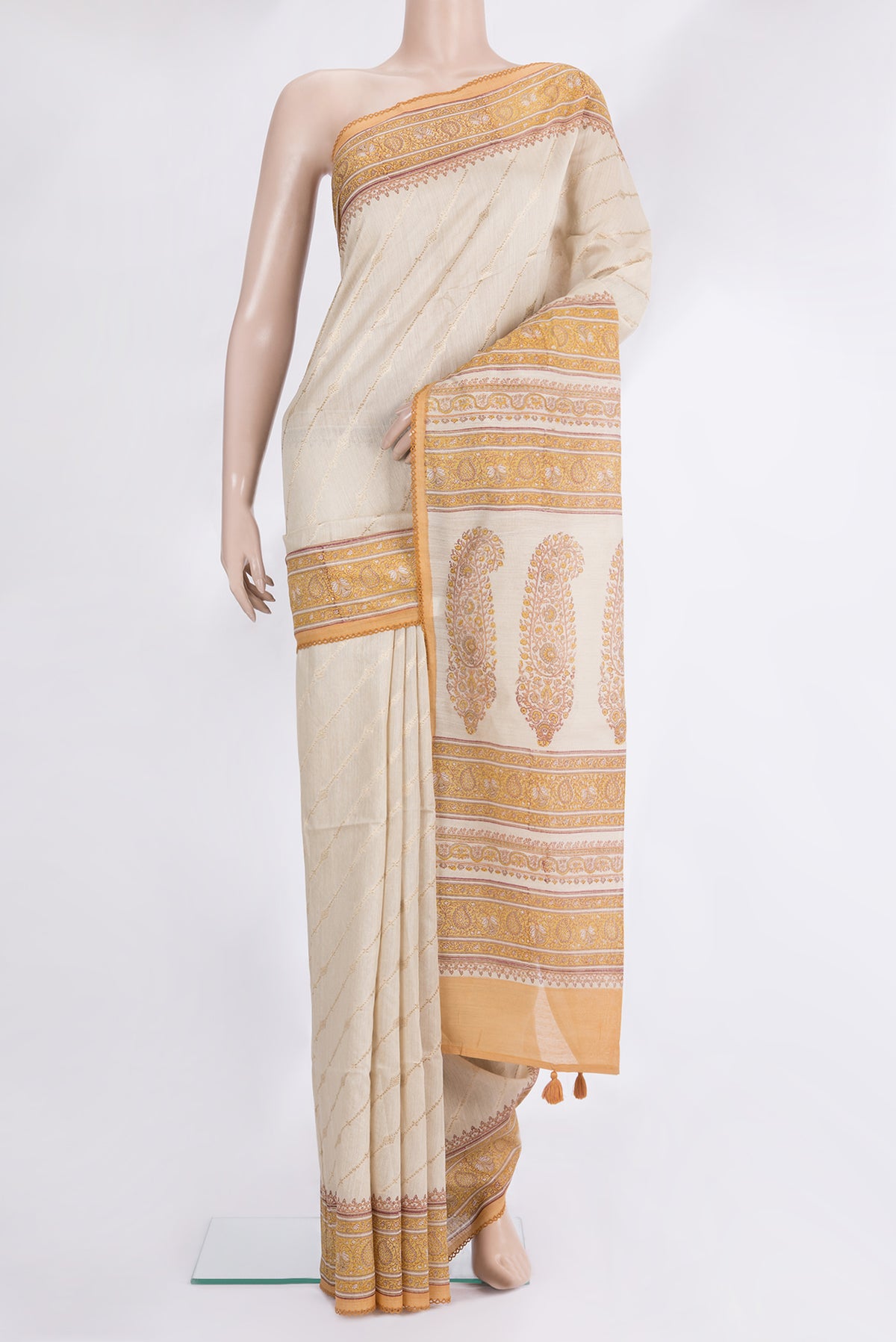 Beige Tussar Saree with Zari Butta on the body and Embroidered Border.  displayed on a mannequin