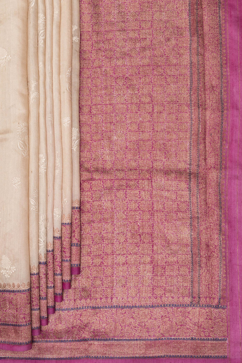 Pleats and pallu of Beige Tussar Saree with Embroidered on the body and Zari Border. 