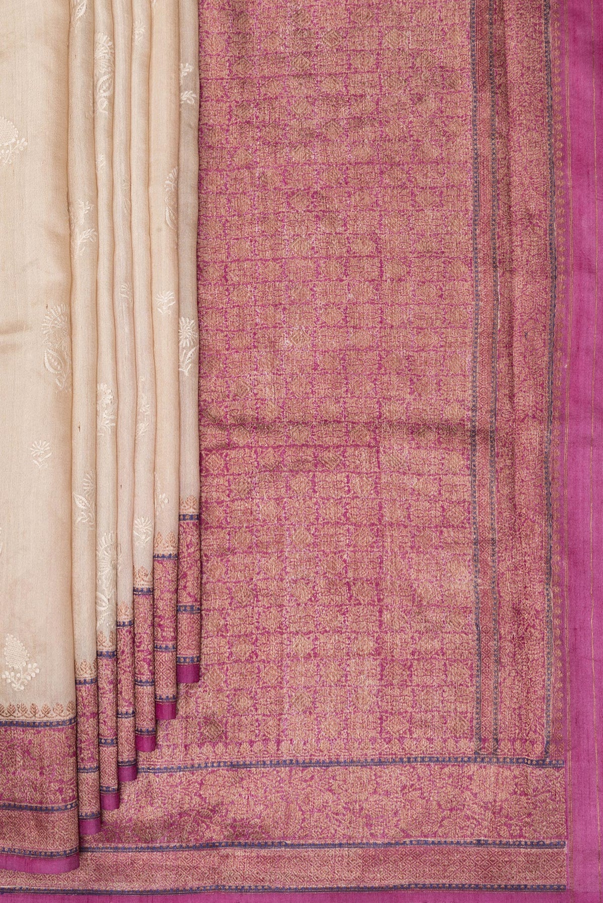 Pleats and pallu of Beige Tussar Saree with Embroidered on the body and Zari Border. 