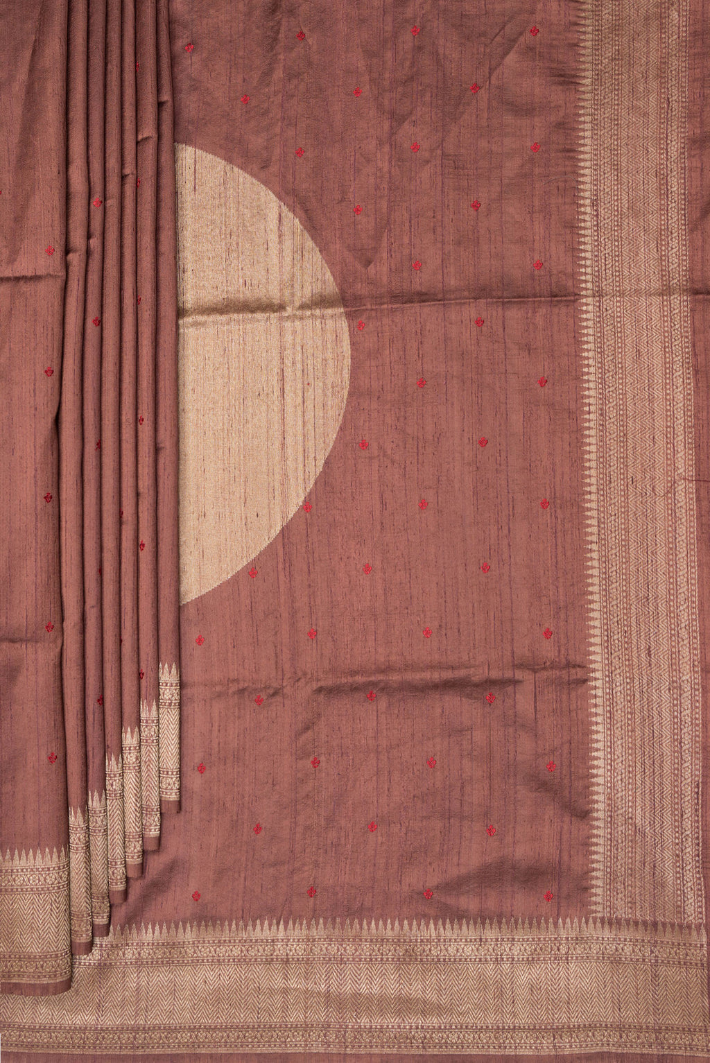 Pleats and pallu of Brown Tussar Saree with Embroidered on the body and Zari Border. 