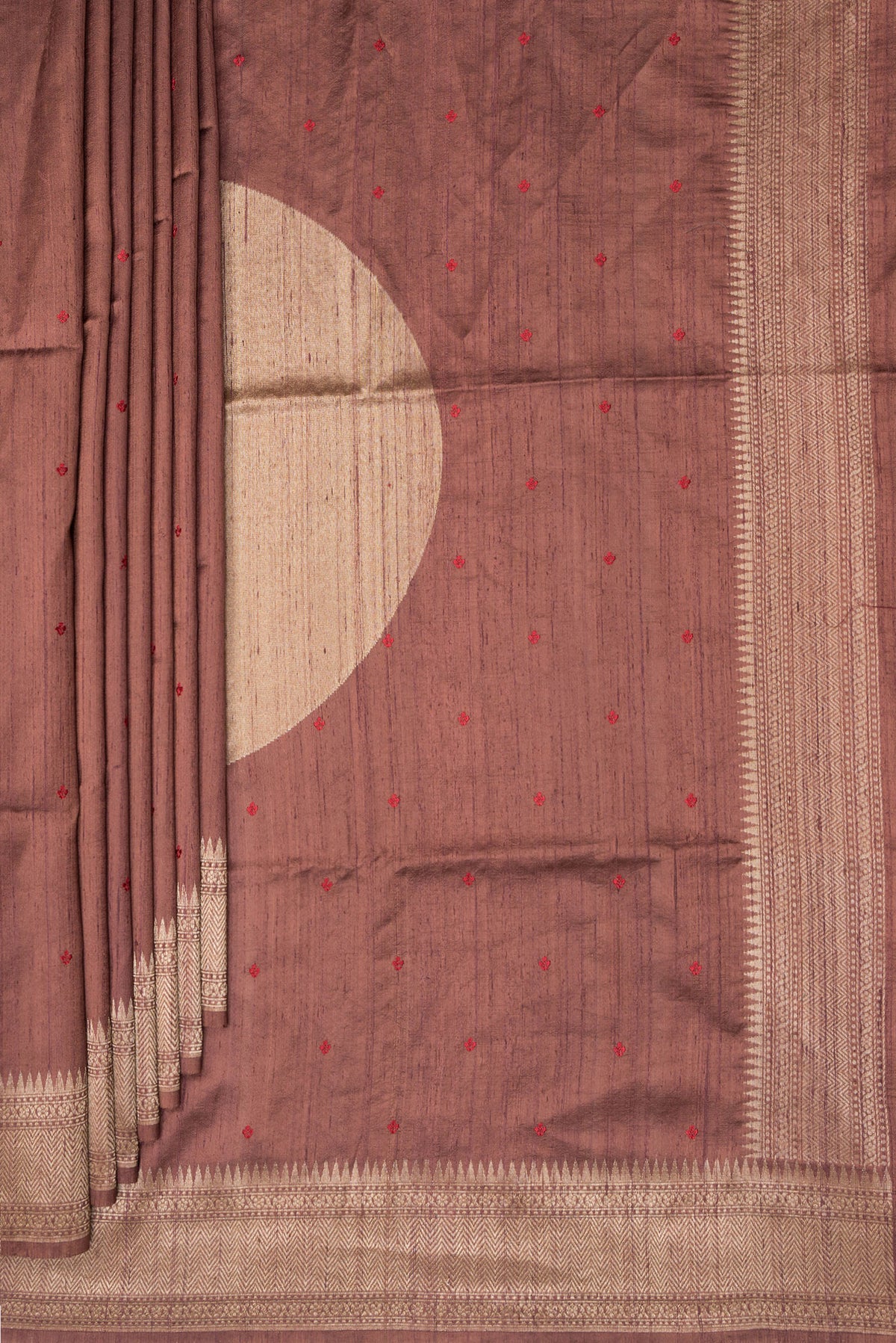 Pleats and pallu of Brown Tussar Saree with Embroidered on the body and Zari Border. 