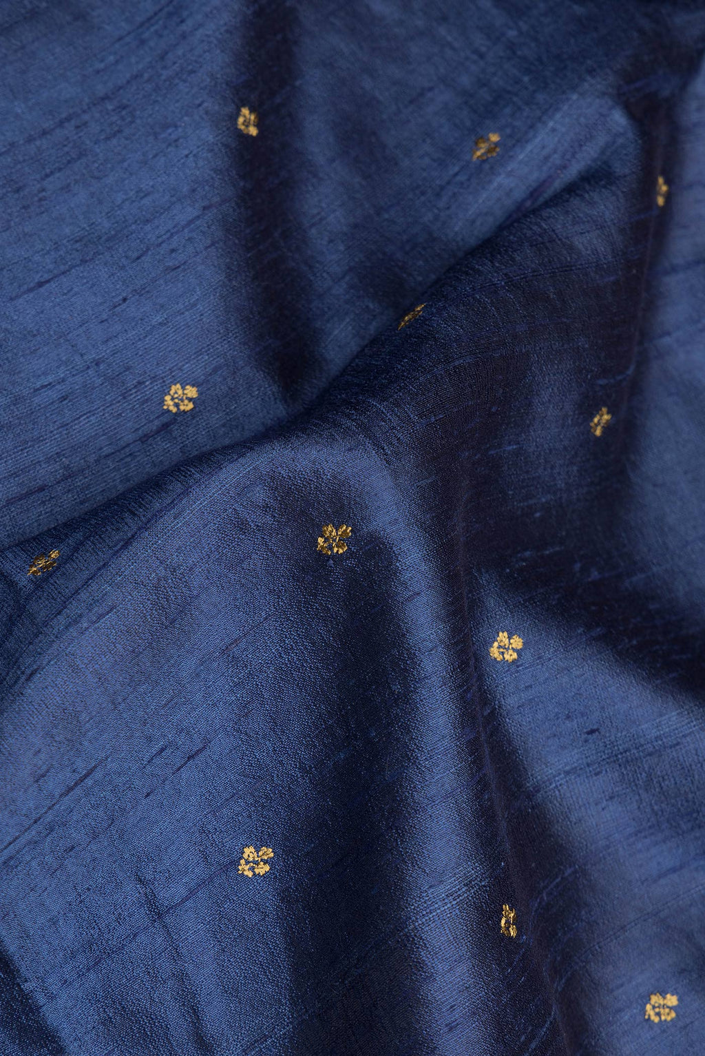 Close up of Pure Silk Dark Blue Tussar Saree with Embroidery on the body and Zari Border.  displaying folds