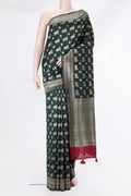 Pure Silk Bottle Green Tussar Saree with Zari Butta on the body and Zari Border.  displayed on a mannequin