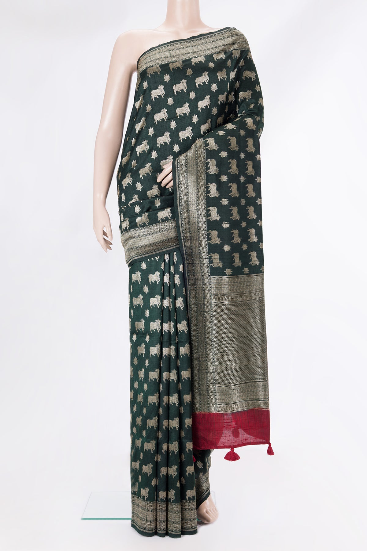 Pure Silk Bottle Green Tussar Saree with Zari Butta on the body and Zari Border.  displayed on a mannequin