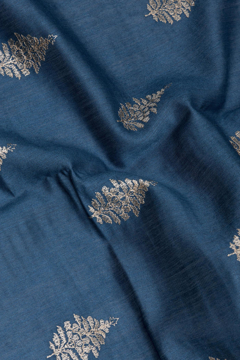 Close up of Maya Blue Tussar Silk Saree with Embroidery on the body and Fancy Border.  displaying folds