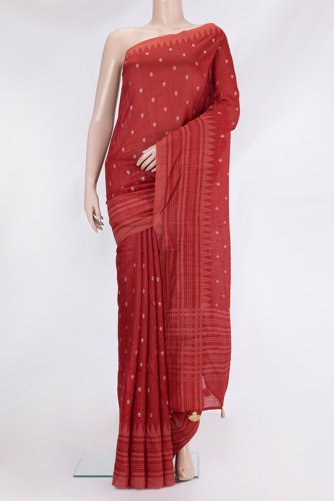 Red Tussar Silk Saree with Embroidery on the body and Fancy Border.  displayed on a mannequin