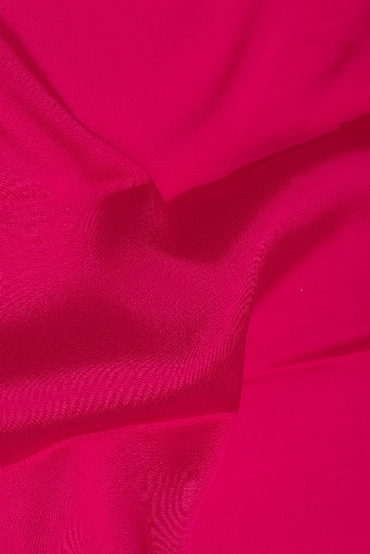 Close up of Pure Silk Dark Pink Mysore Silk Saree with Plain Body and Zari Border.  displaying folds