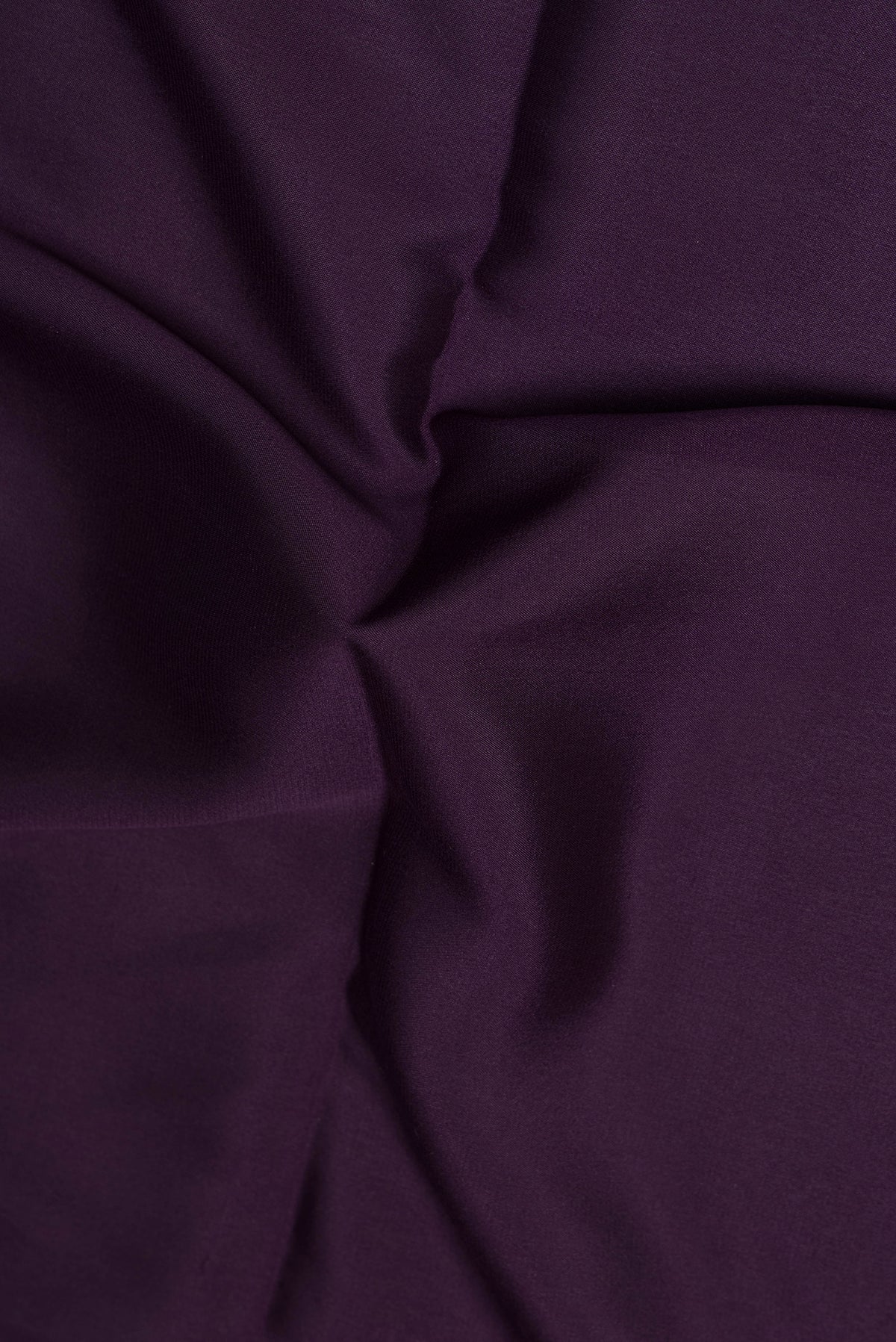 Close up of Purple Mysore Crepe Saree with Plain Body and Zari Border.  displaying folds