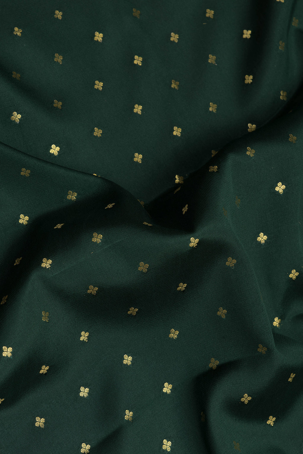 Close up of Bottle Green Mysore Chiffon Saree with Zari Butta on the body and Zari Border.  displaying folds