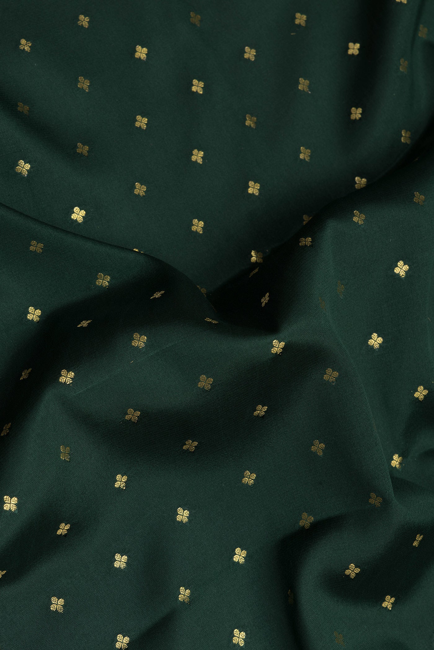Close up of Bottle Green Mysore Chiffon Saree with Zari Butta on the body and Zari Border.  displaying folds
