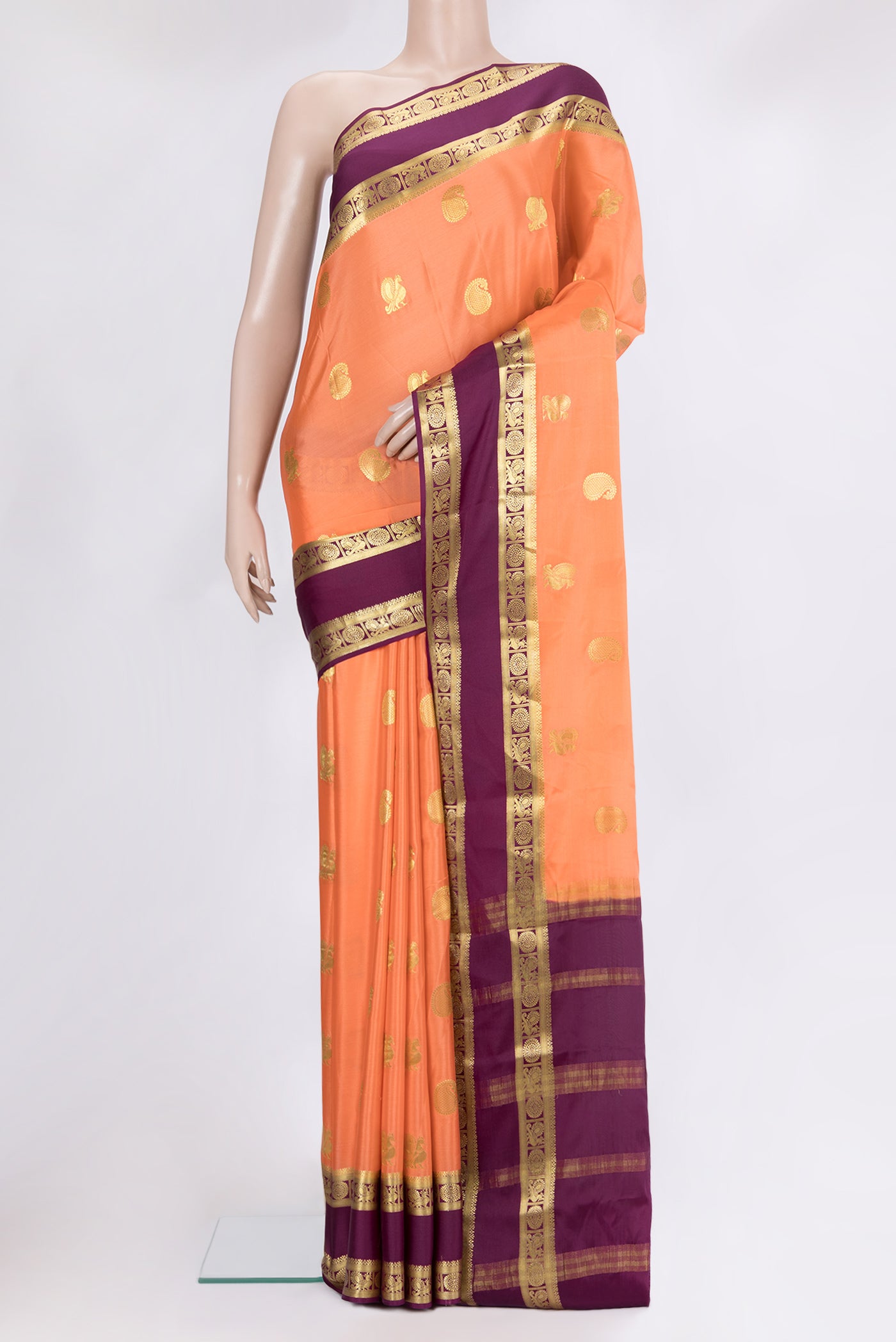 Golden Peach Mysore Crepe Saree with Zari Butta on the body and Fancy Border.  displayed on a mannequin