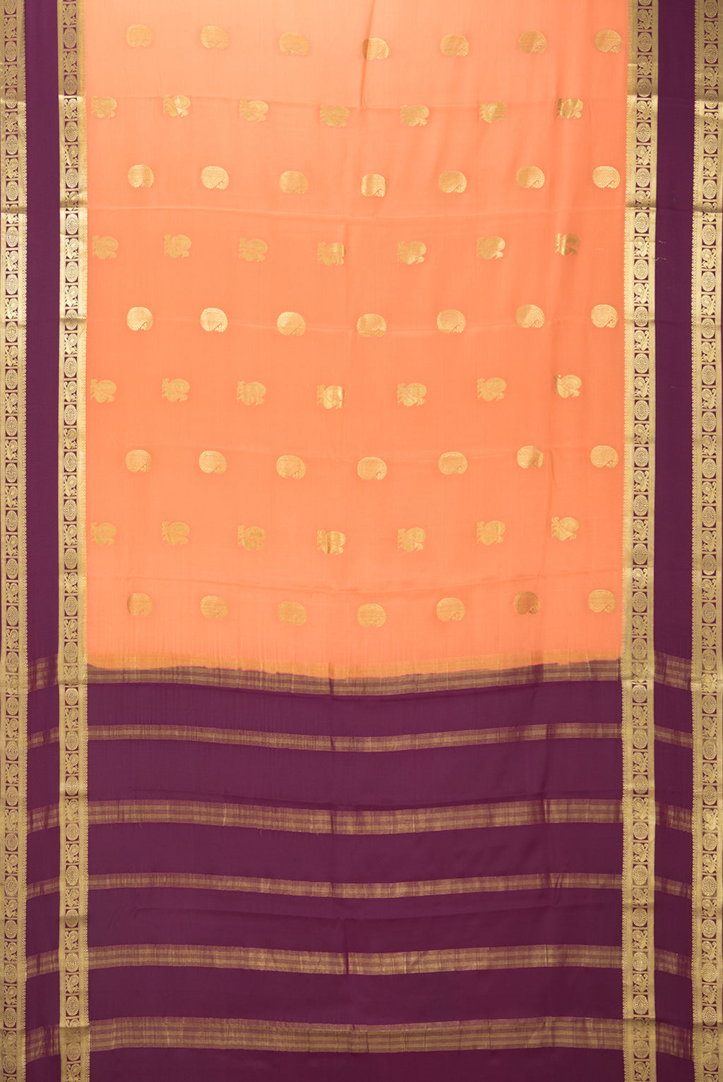 Flat view of Golden Peach Mysore Crepe Saree with Zari Butta on the body and Fancy Border. 