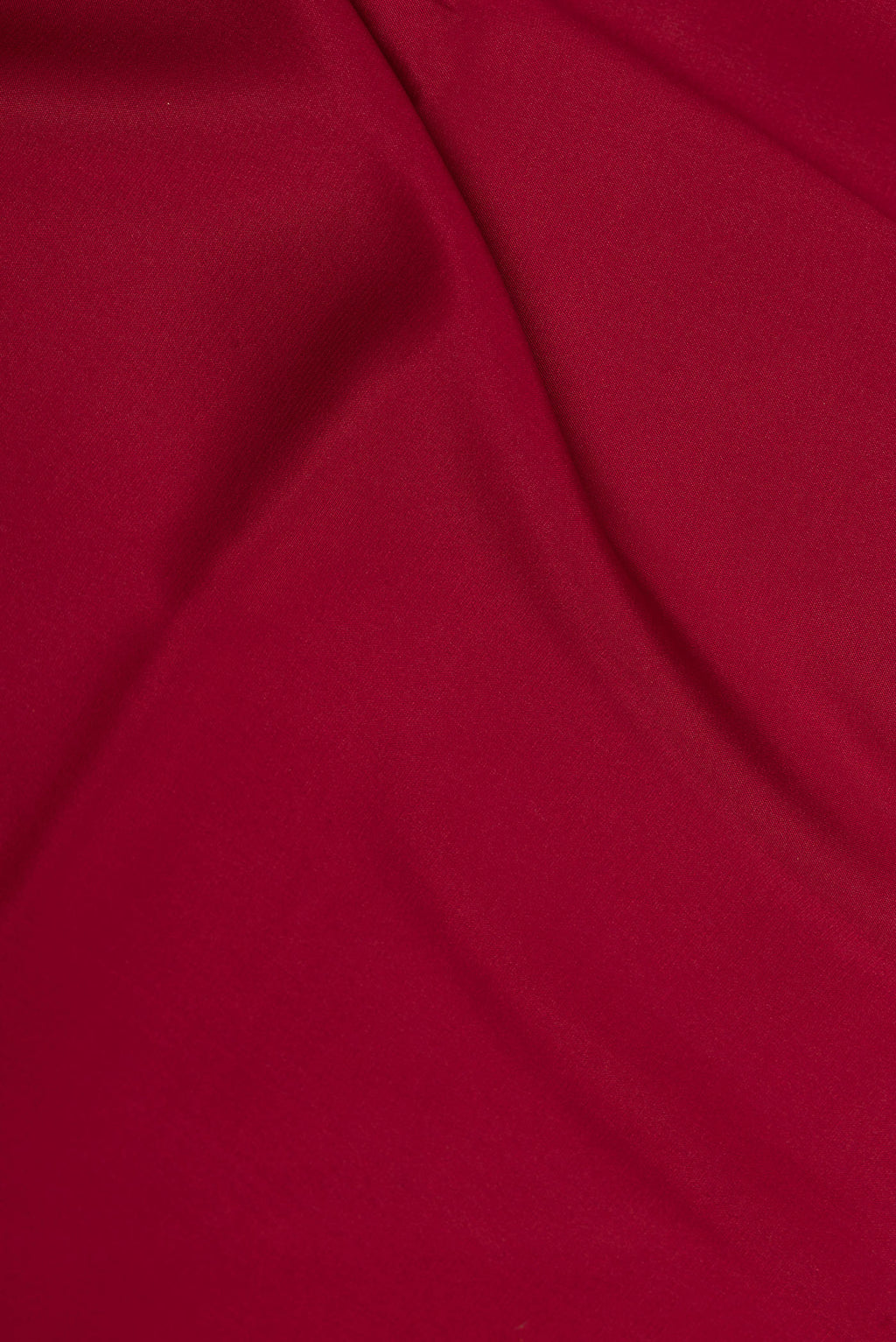 Close up of Deep Red Dual Tone Mysore Crepe Saree with Plain Body and Zari Border.  displaying folds