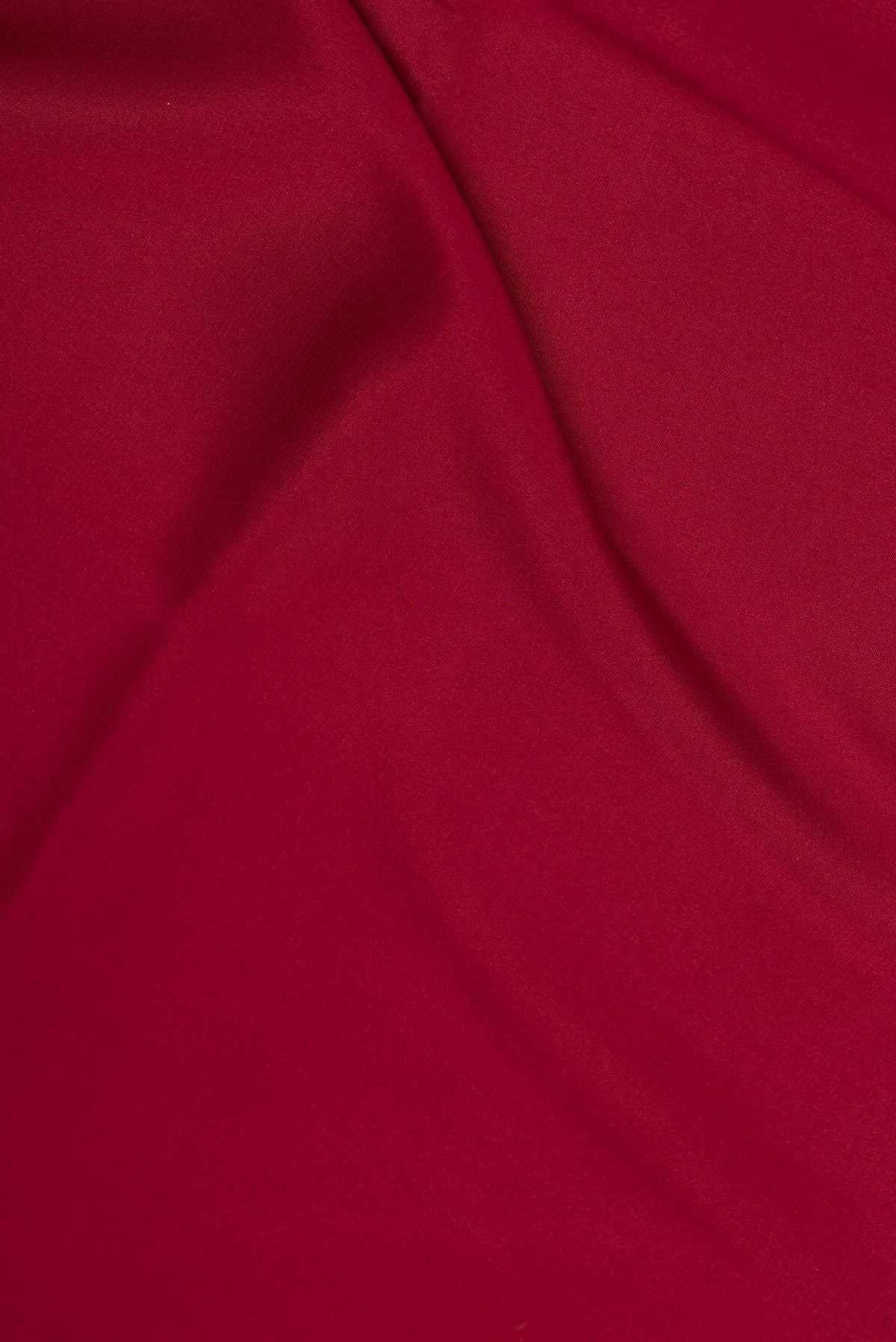 Close up of Deep Red Dual Tone Mysore Crepe Saree with Plain Body and Zari Border.  displaying folds
