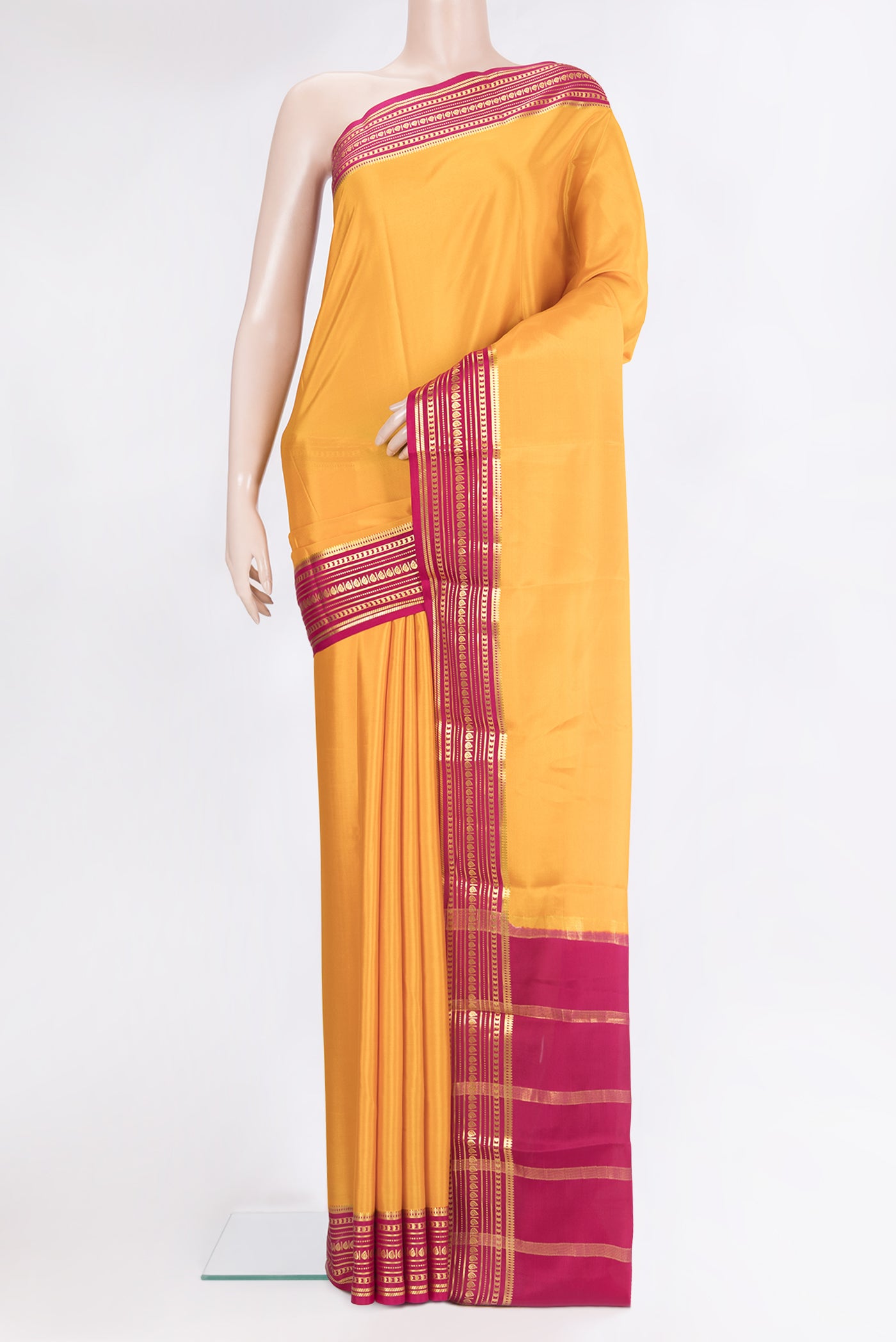 Pure Silk Yellow Mysore Silk Saree with Plain Body and Zari Border.  displayed on a mannequin