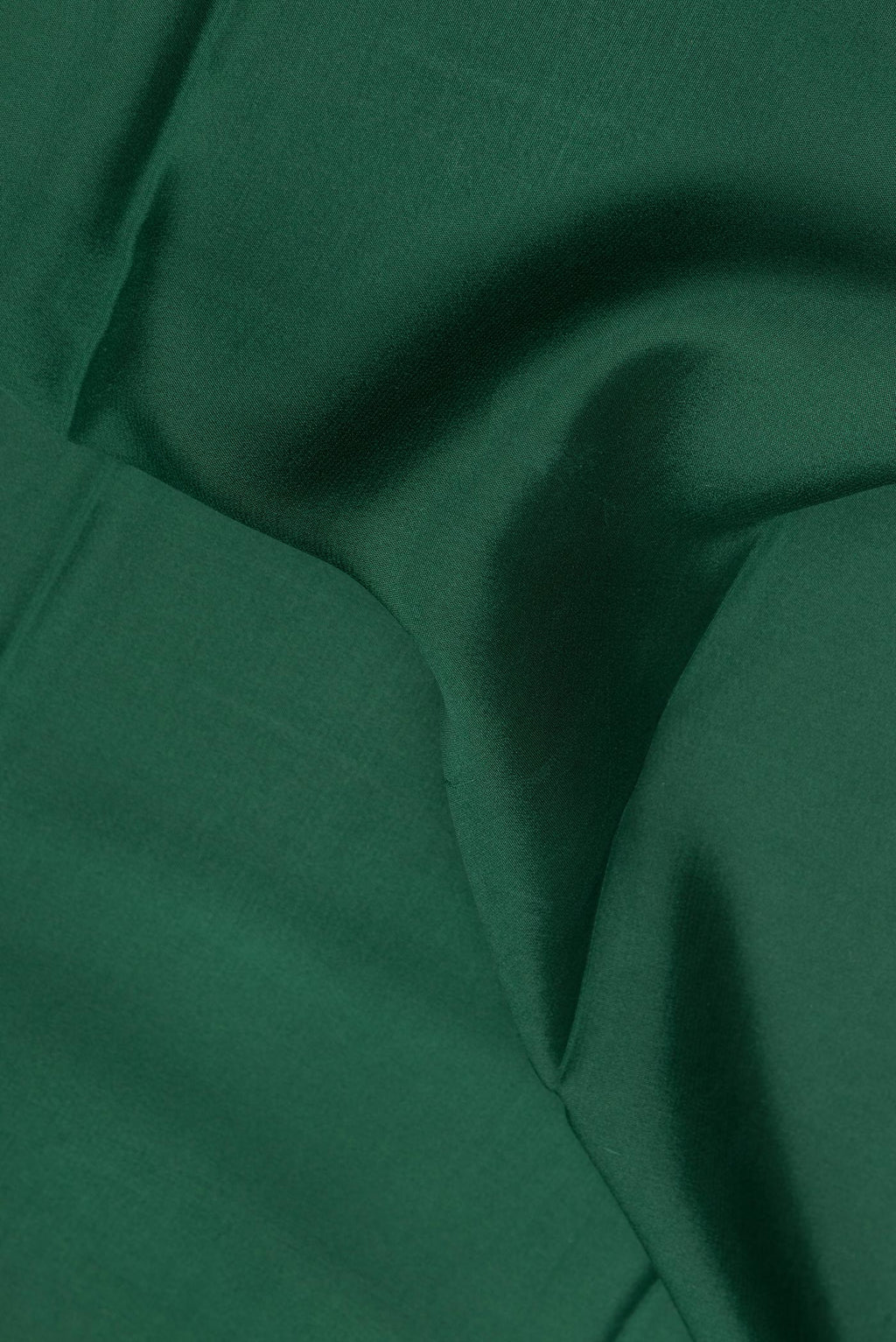 Close up of Bottle Green Mysore Crepe Saree with Plain Body and Fancy Border.  displaying folds