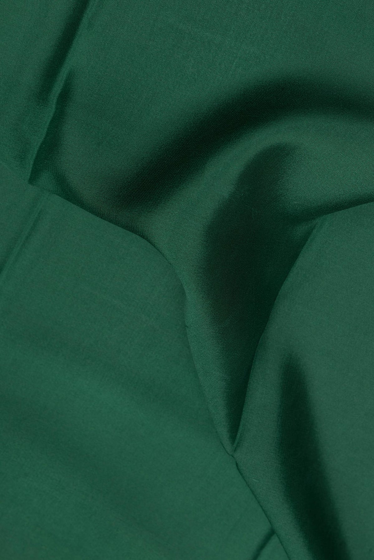 Close up of Bottle Green Mysore Crepe Saree with Plain Body and Fancy Border.  displaying folds