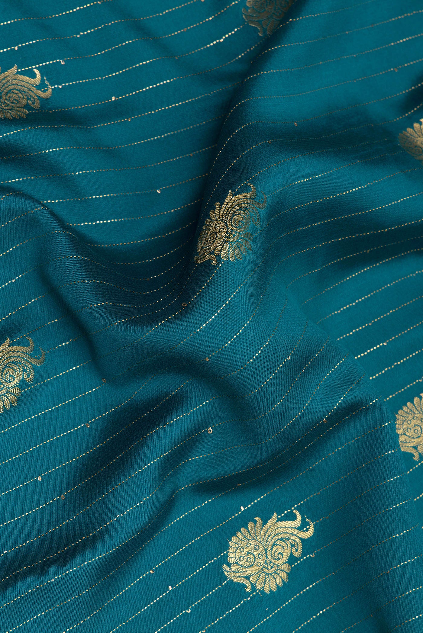 Close up of Pure Silk Blue Mysore Silk Saree with Zari Butta on the body and Zari Border.  displaying folds
