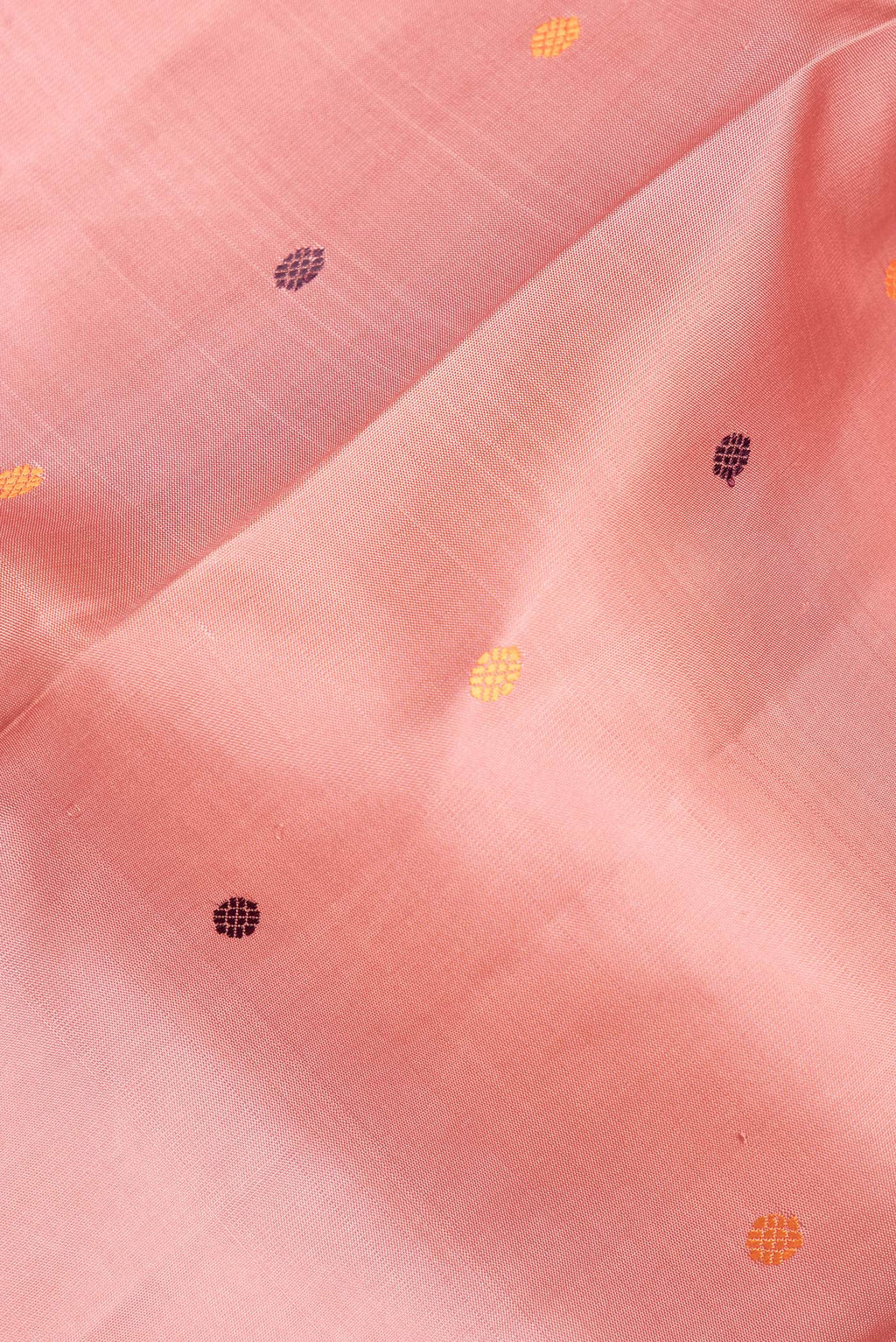 Close up of Pure Silk Peach Kanjivaram Saree with Thread Butta on the body and Thread Border.  displaying folds