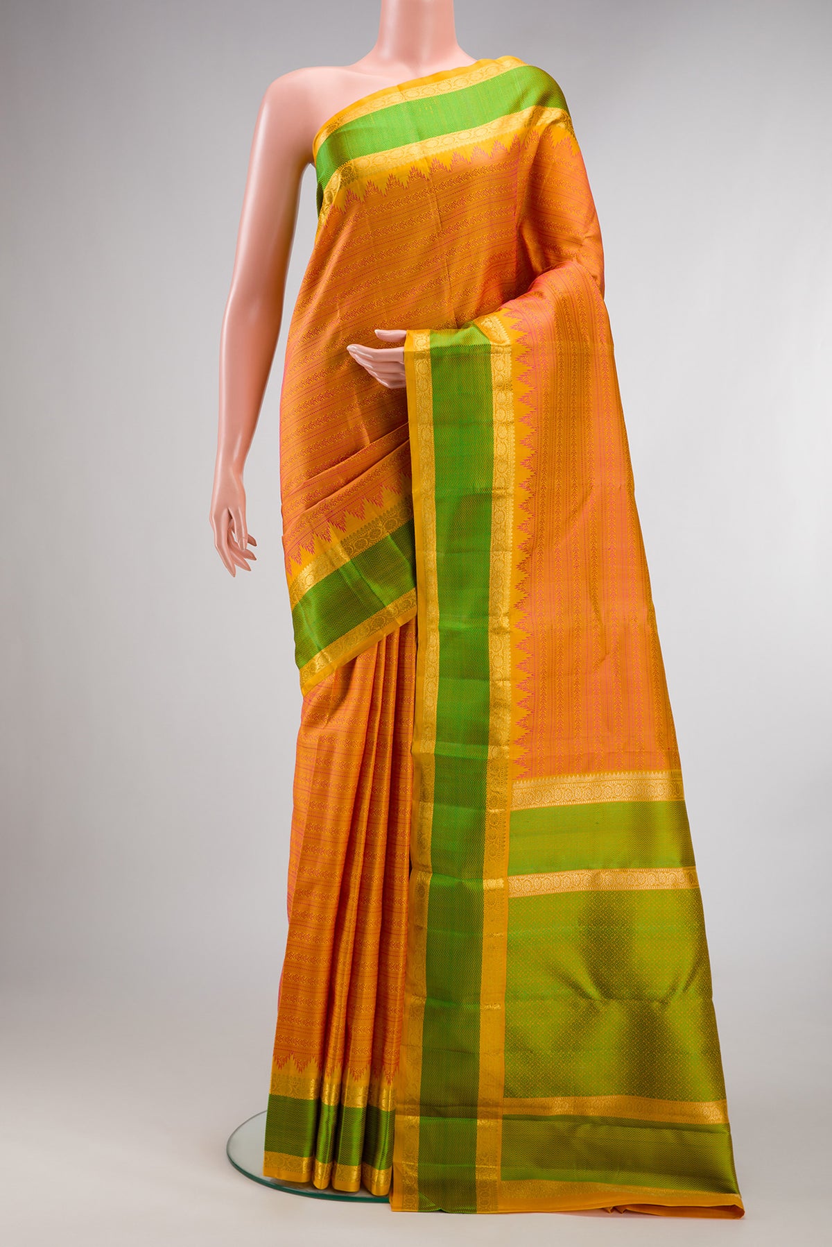 Pure Silk Pure Zari Orange Kanjivaram Saree with Jacquard design on the body and Zari And Thread Border.  displayed on a mannequin