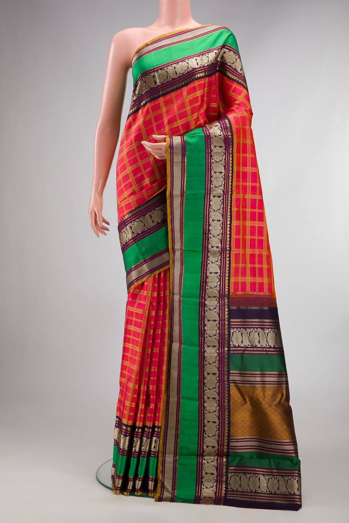 Pure Silk Pure Zari Coral Dual Tone Kanchipuram Saree with Checked design on the body and Zari And Thread Border.  displayed on a mannequin