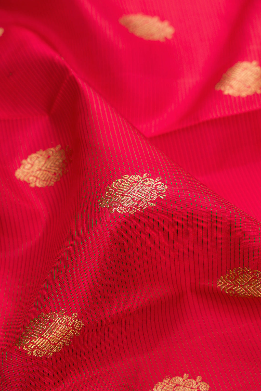 Close up of Pure Silk Pure Zari Red Kanjivaram Saree with Stripes on the body and Zari Border.  displaying folds