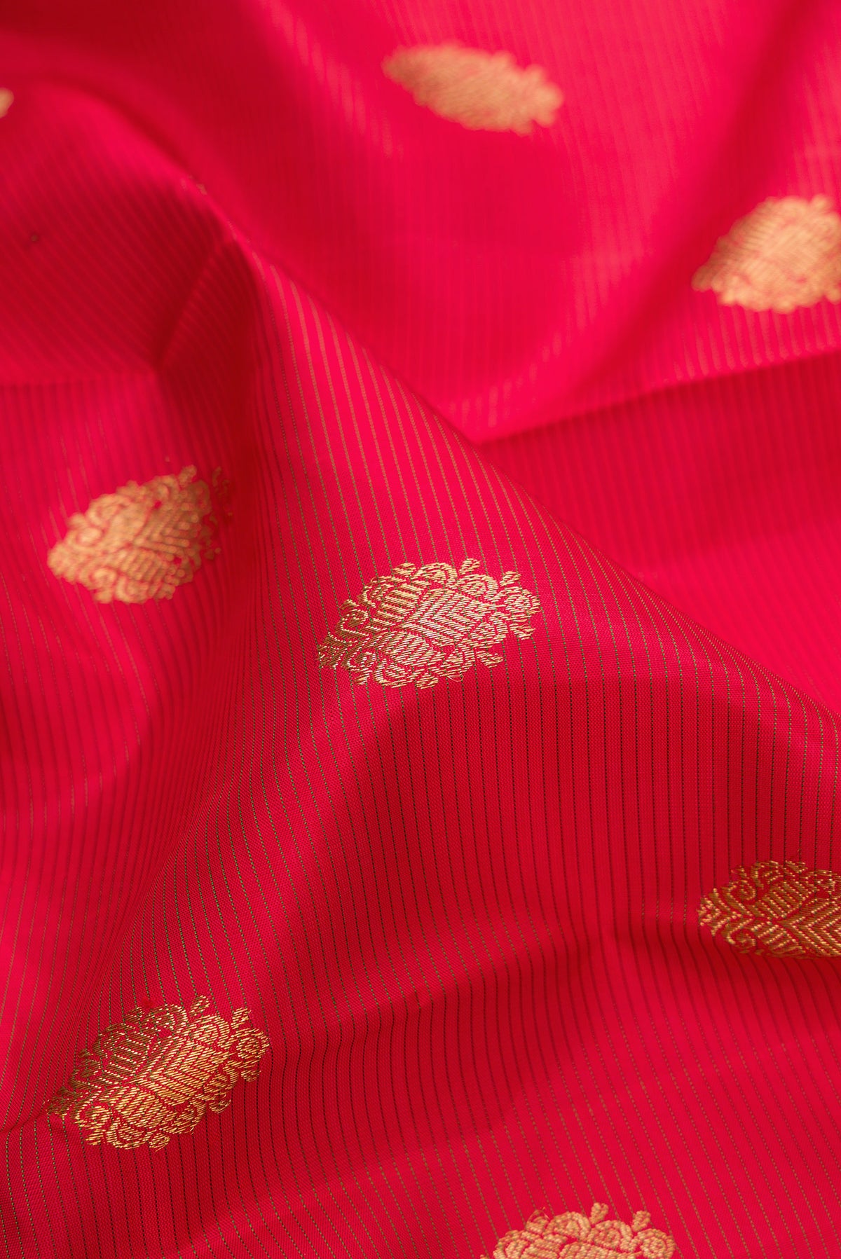 Close up of Pure Silk Pure Zari Red Kanjivaram Saree with Stripes on the body and Zari Border.  displaying folds