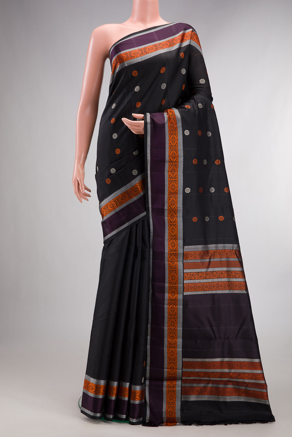Pure Silk Black Kanjivaram Saree with Thread Butta on the body and Thread Border.  displayed on a mannequin