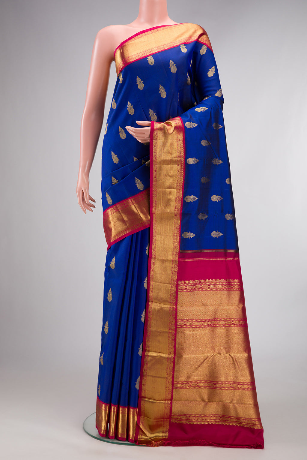Pure Silk Pure Zari Royal Blue Kanjivaram Saree with Zari Butta on the body and Zari Border.  displayed on a mannequin