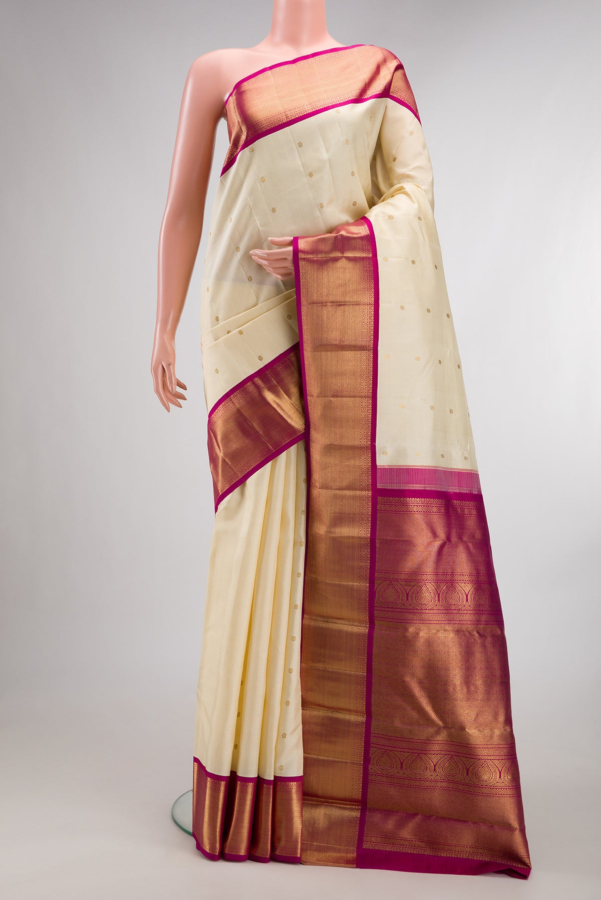 Pure Silk Pure Zari Cream Kanjivaram Saree with Zari Butta on the body and Zari Border.  displayed on a mannequin