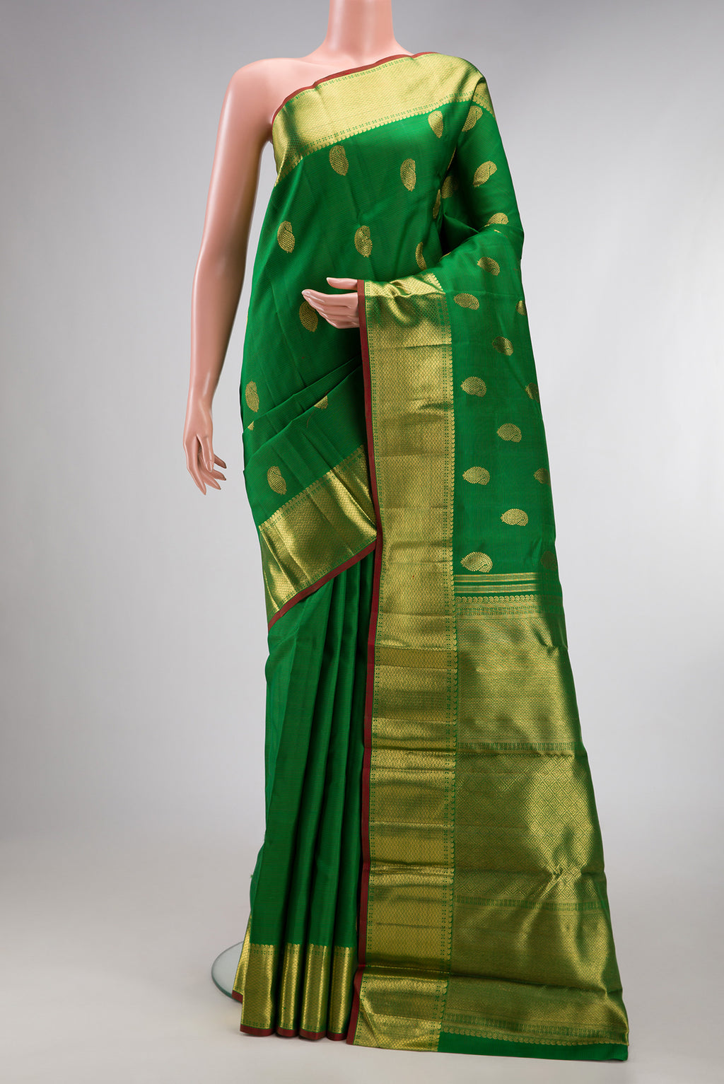 Pure Silk Pure Zari Green Kanjivaram Saree with Zari Butta on the body and Zari Border.  displayed on a mannequin