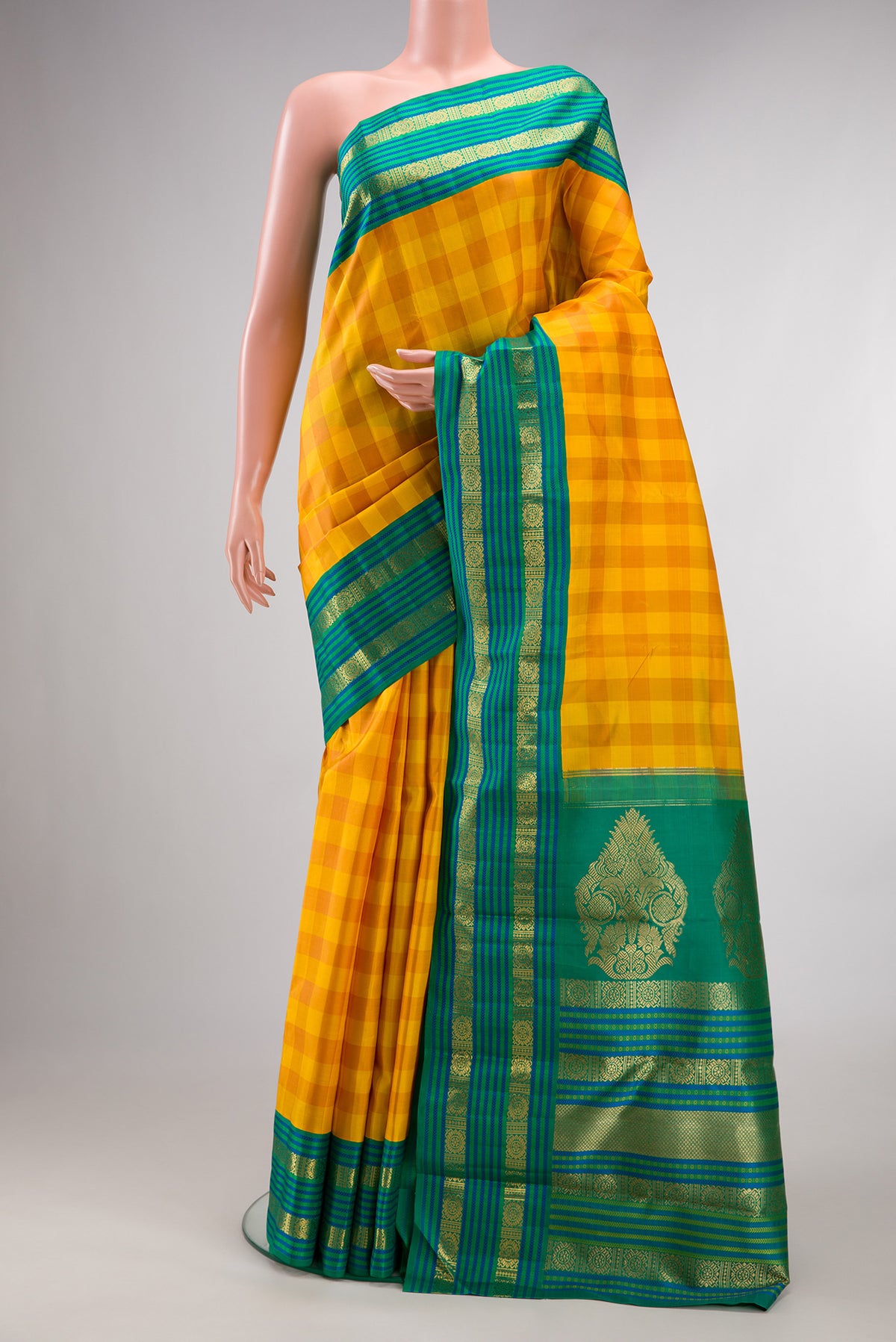 Pure Silk Pure Zari Yellow Kanjivaram Saree with Checked design on the body and Zari Border.  displayed on a mannequin
