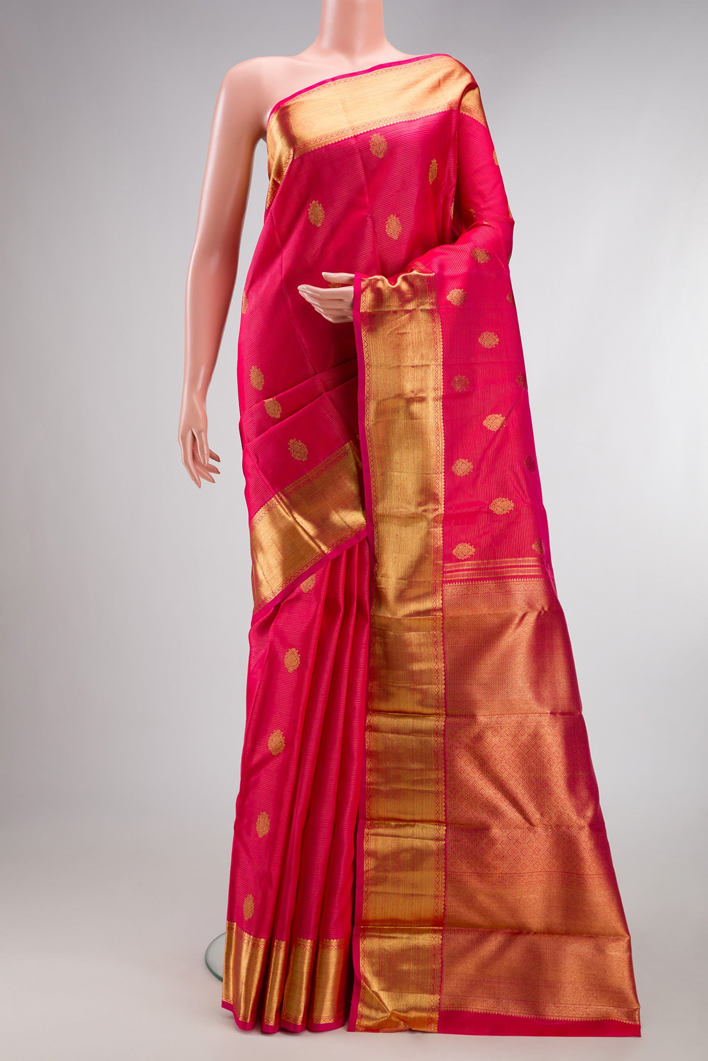 Pure Silk Pure Zari Dark Pink Kanjivaram Saree with Zari Butta on the body and Zari Border.  displayed on a mannequin