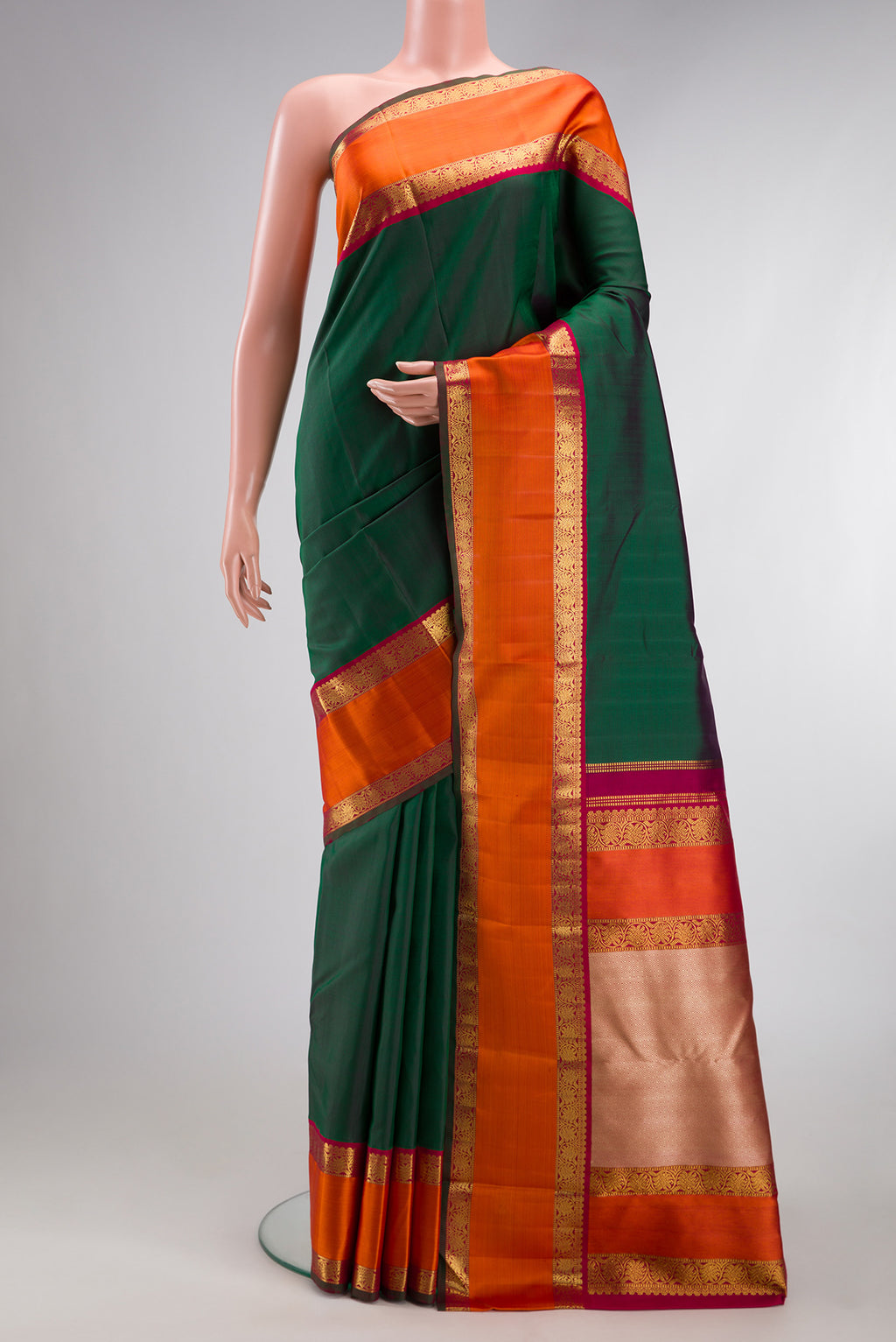 Pure Silk Pure Zari Green Kanjivaram Saree with Plain Body and Zari Border.  displayed on a mannequin