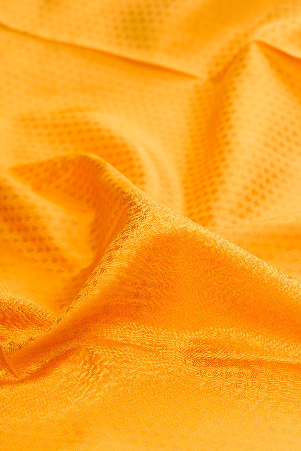 Close up of Pure Silk Pure Zari Yellow Kanjivaram Saree with Jacquard design on the body and Zari Border.  displaying folds