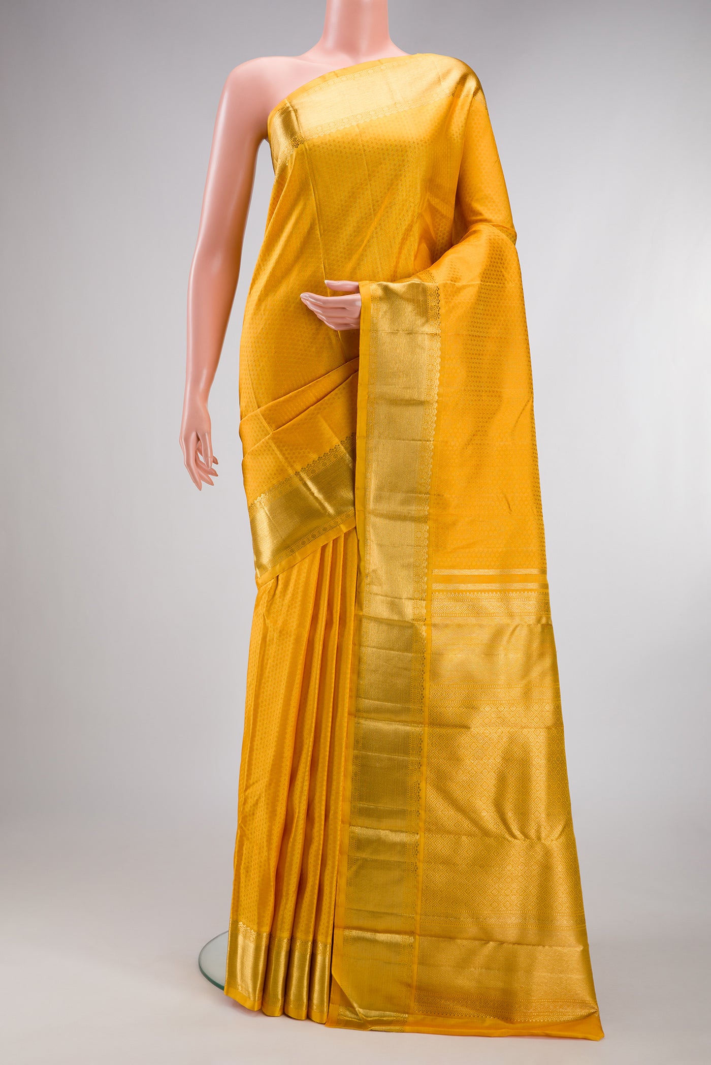 Pure Silk Pure Zari Yellow Kanjivaram Saree with Jacquard design on the body and Zari Border.  displayed on a mannequin